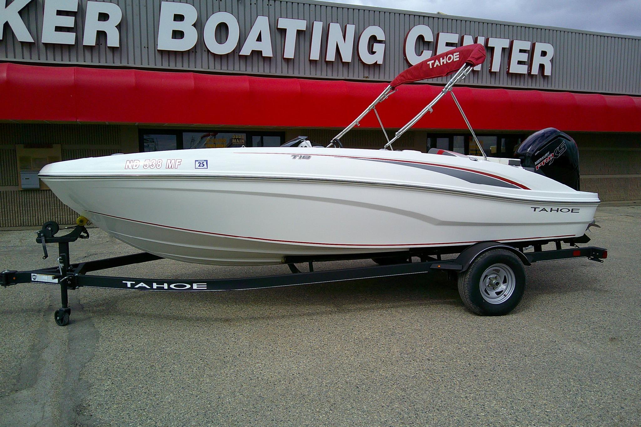 2024 Tahoe T18 boat on trailer outside a boating center.