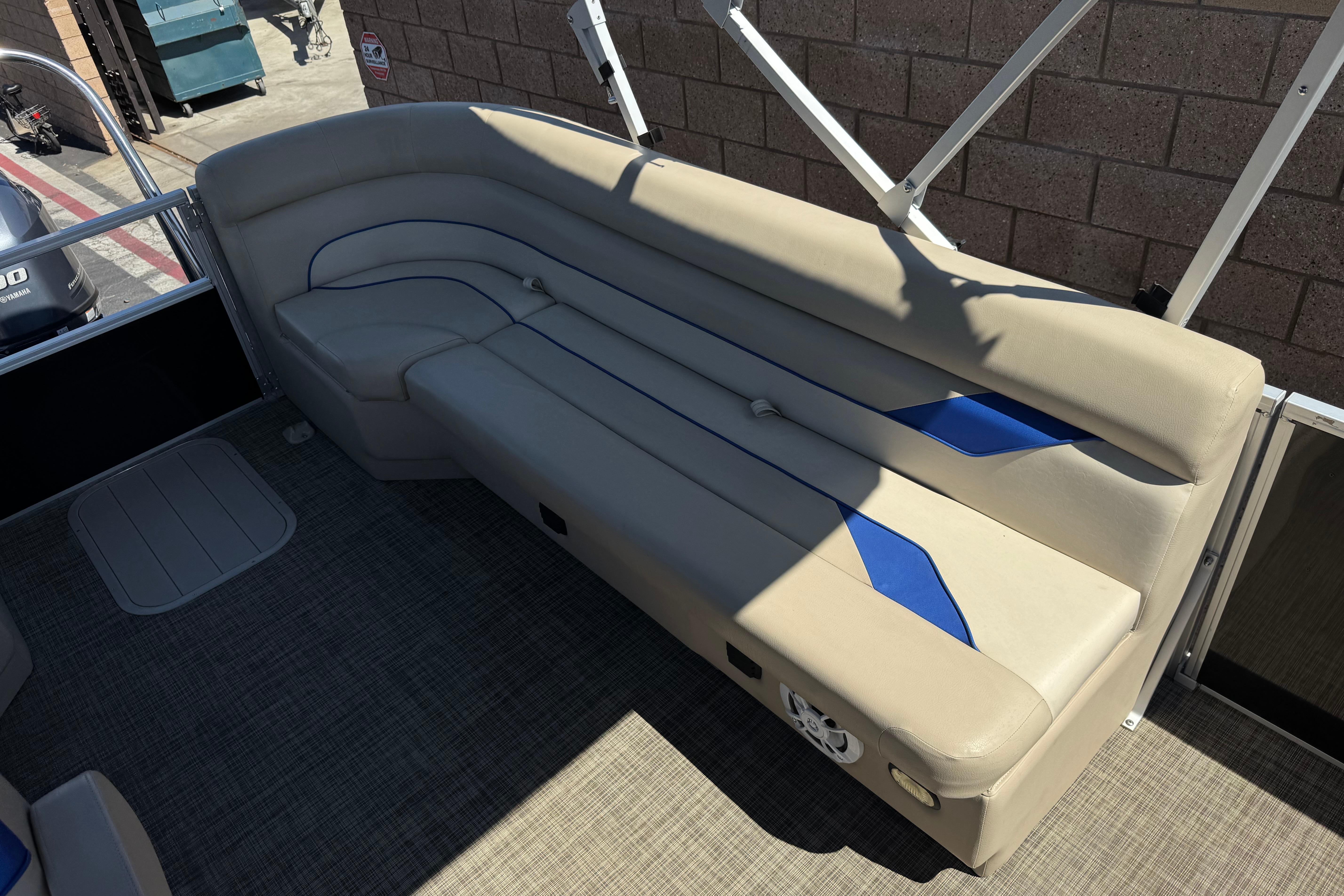2021 SunCatcher Select 20RCX pontoon boat interior with beige seating and blue accents.