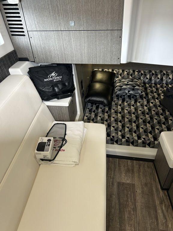 2023 Monterey 378SS interior with modern seating, geometric bedding, and sleek design elements.