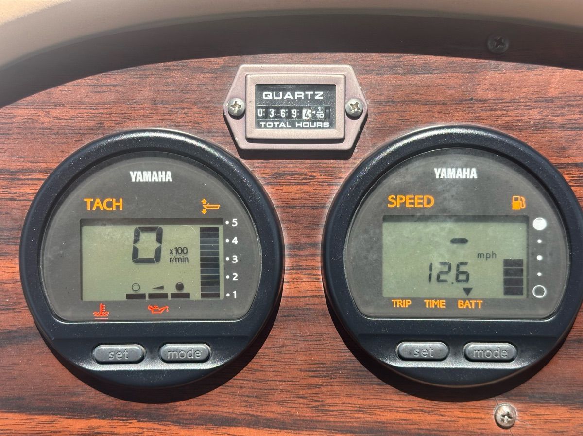 Close-up of Yamaha instruments on a boat, displaying RPM and speed.