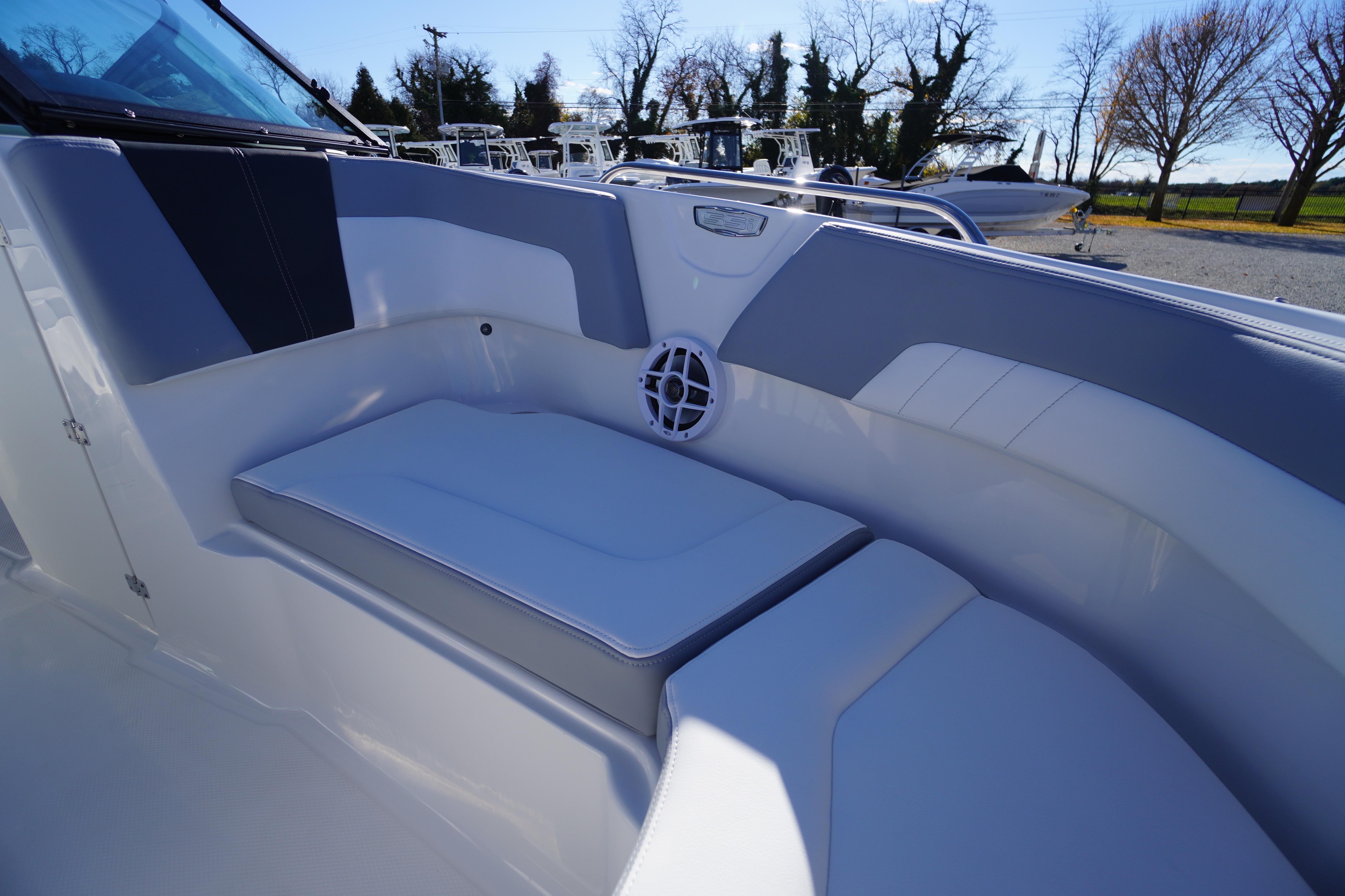 2026 Chaparral 23 SSi boat interior with cushioned seating and speaker.