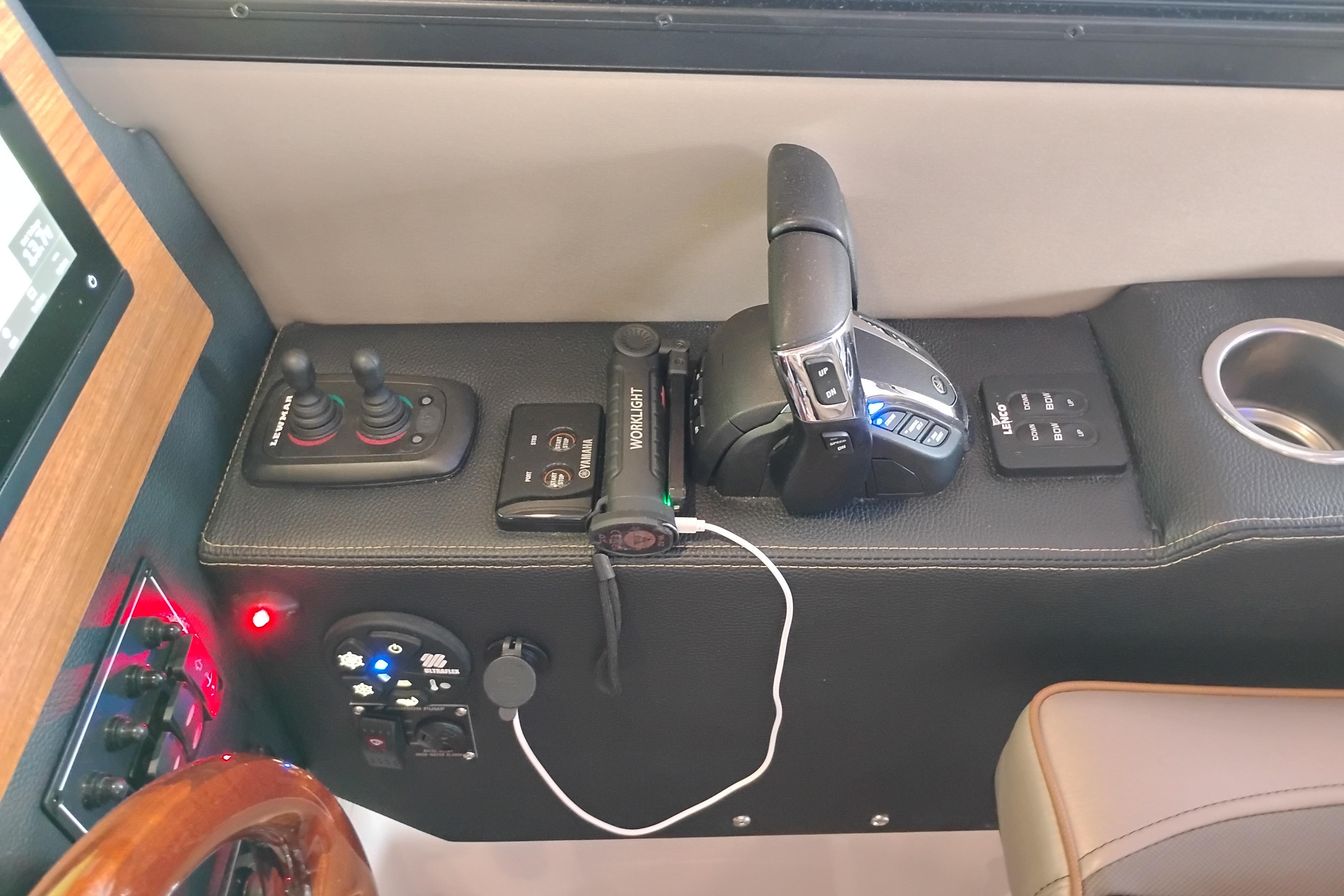 2022 Cutwater C-32 Coupe helm controls with joystick, throttle, and cup holder.