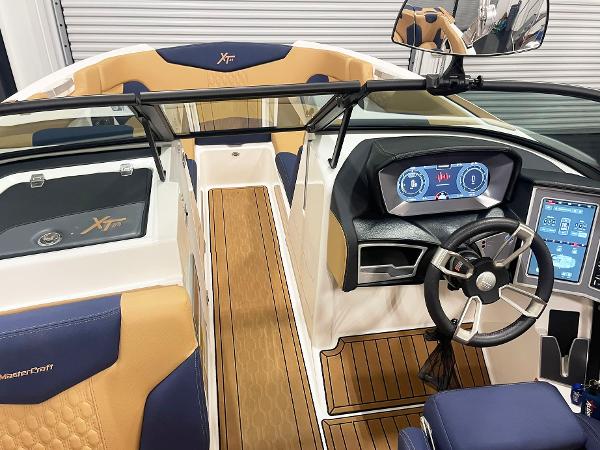 2022 MasterCraft NXT24 boat interior with modern dashboard and luxurious seating.