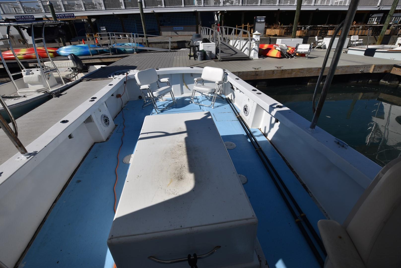 Open deck of a 2011 Custom Downeast boat docked at a marina.