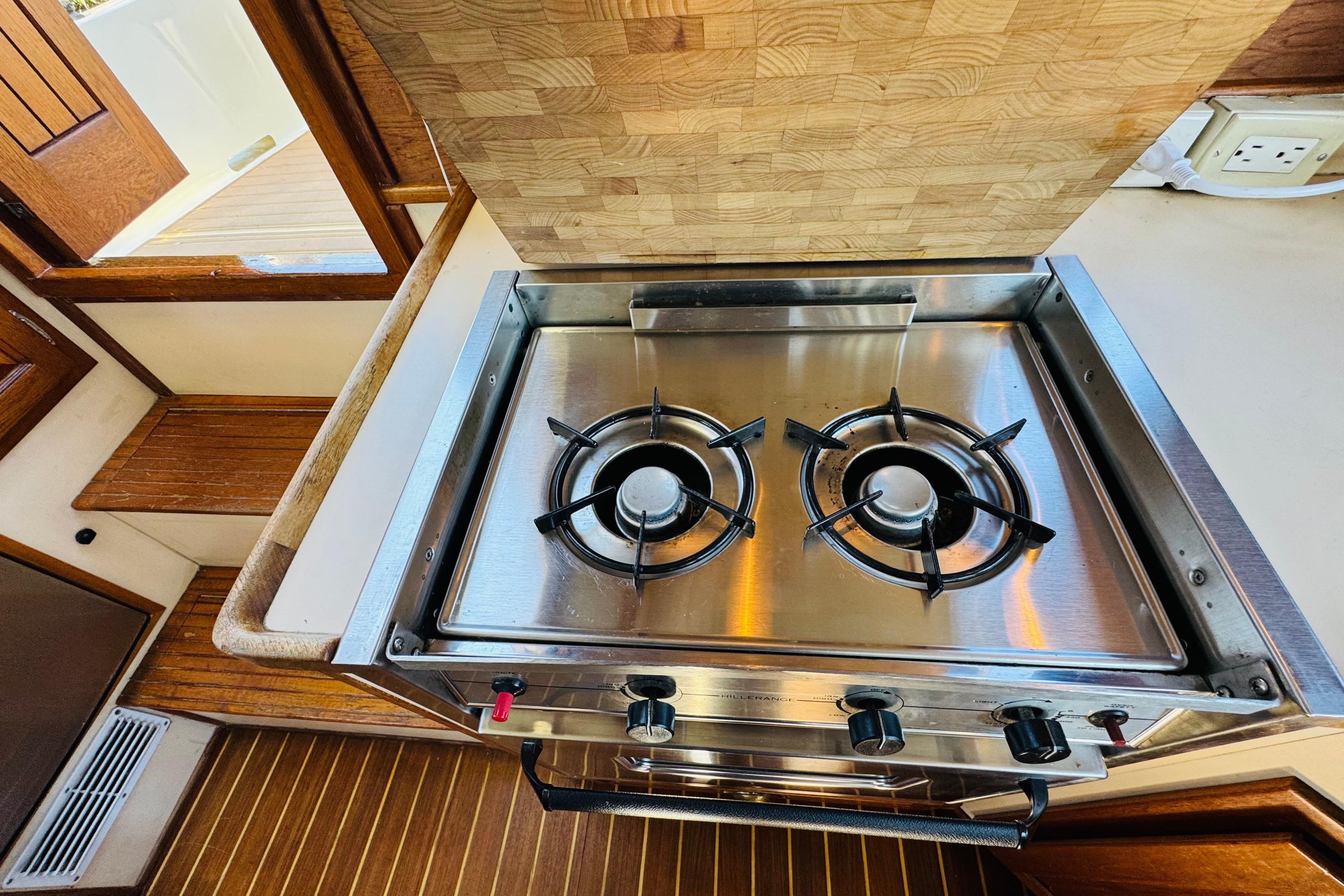 Stainless steel two-burner stove in 1996 Nordic Tug 32 boat kitchen.