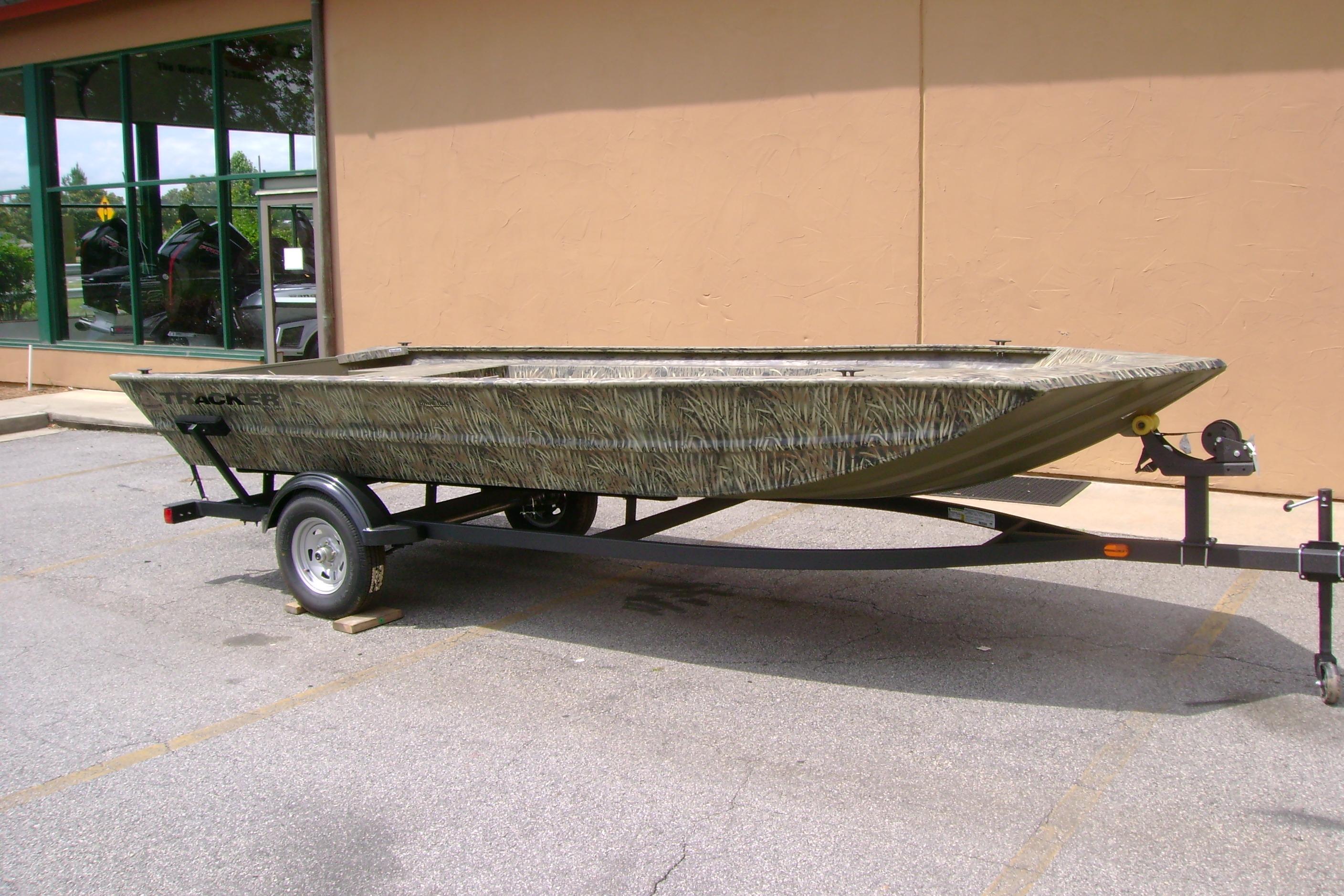2026 Tracker Grizzly 1754 Utility boat on trailer, parked outdoors.