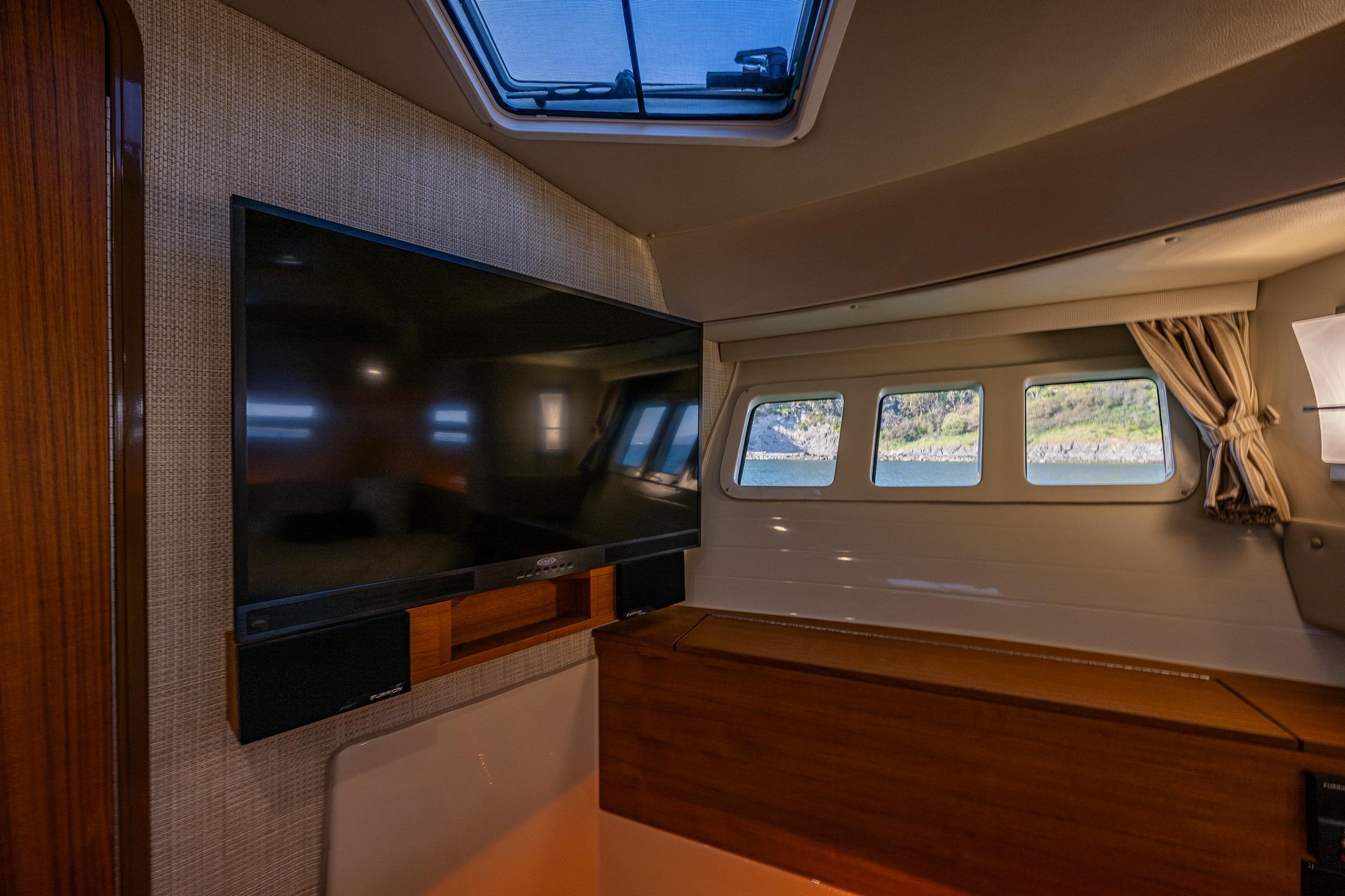 Interior of 2020 Ranger Tugs R-41 CB with TV and scenic window view.
