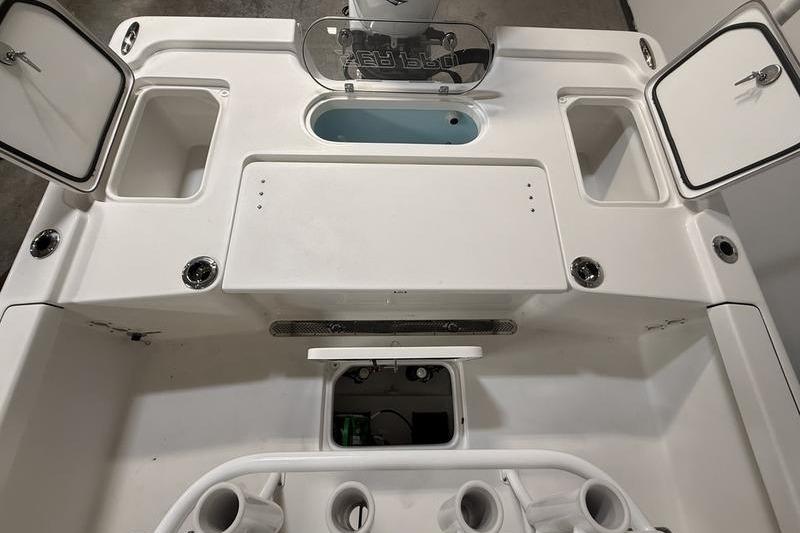 2026 Sea Pro 250 Bay boat interior with storage compartments and livewell.