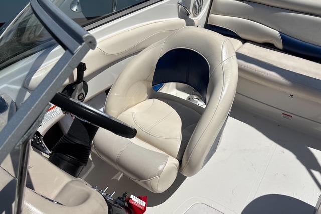 Interior of a 2012 Tahoe Q8 SSi boat with white seating and steering wheel.