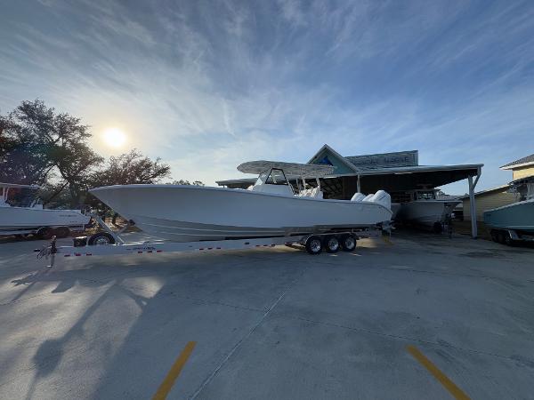 2025 Yellowfin 39 Offshore boat on trailer at marina, under a clear sky.