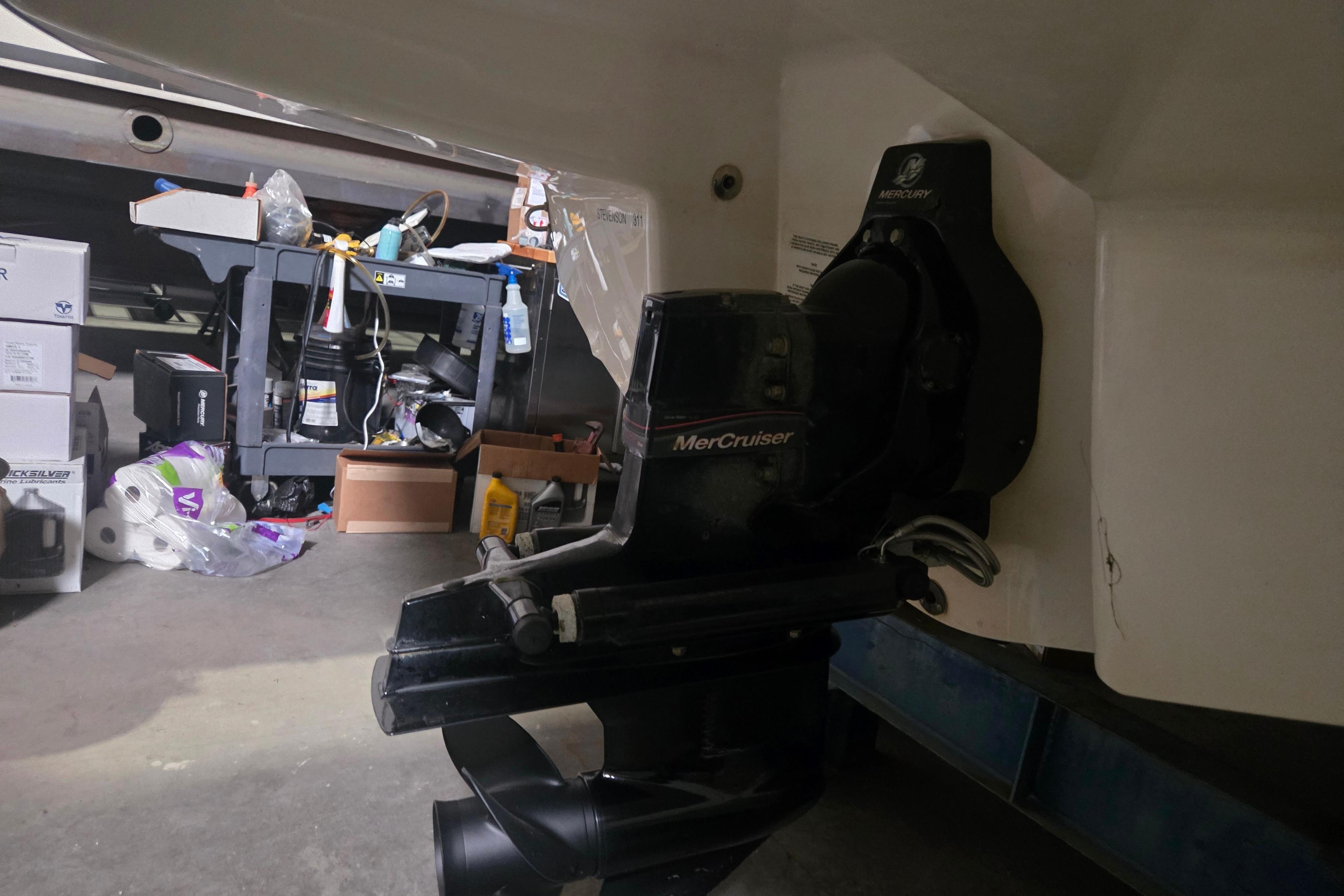 2006 Chaparral 236 SSi boat with MerCruiser engine in a garage setting.