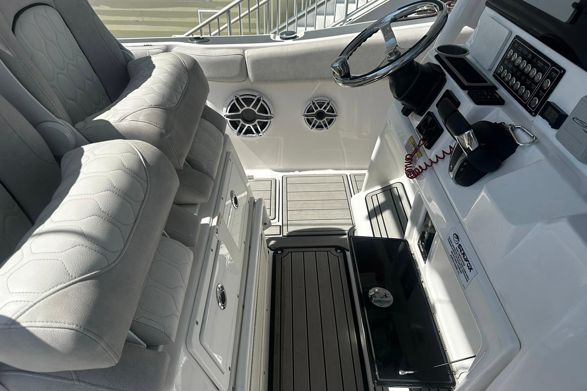 Interior view of 2002 Sea Fox 228 Commander boat with steering wheel and seating.