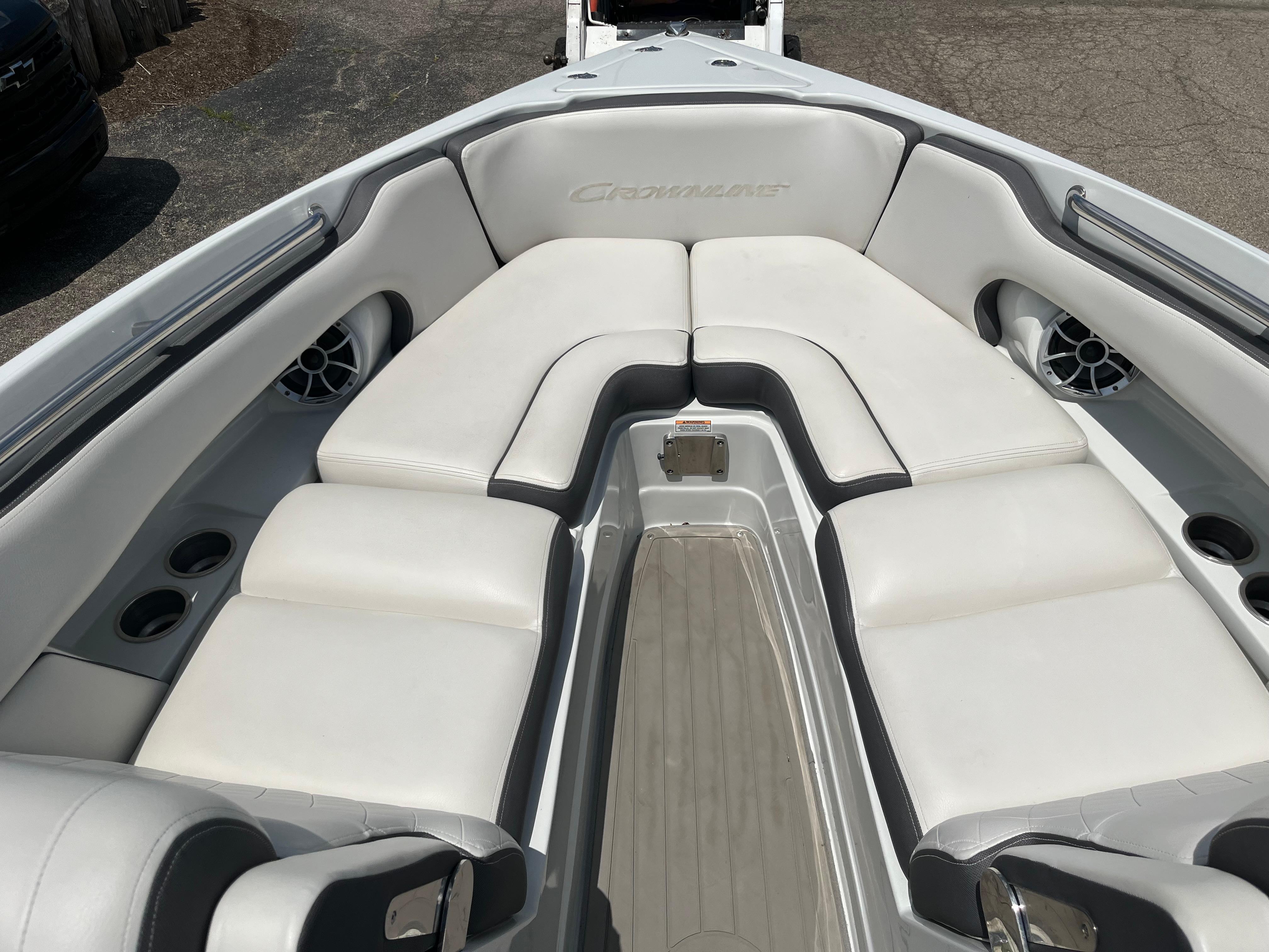 2022 Crownline 280 SS boat interior with white cushioned seating and cup holders.