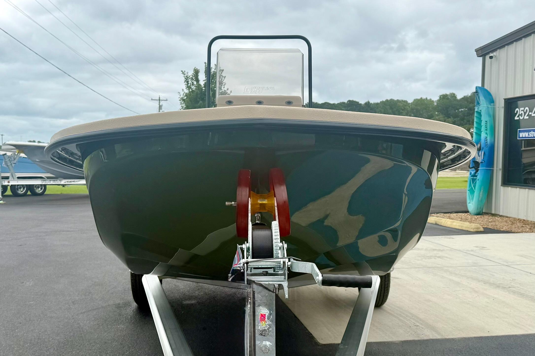 2026 Carolina Skiff E18 JVX CC boat on trailer, front view, overcast sky.
