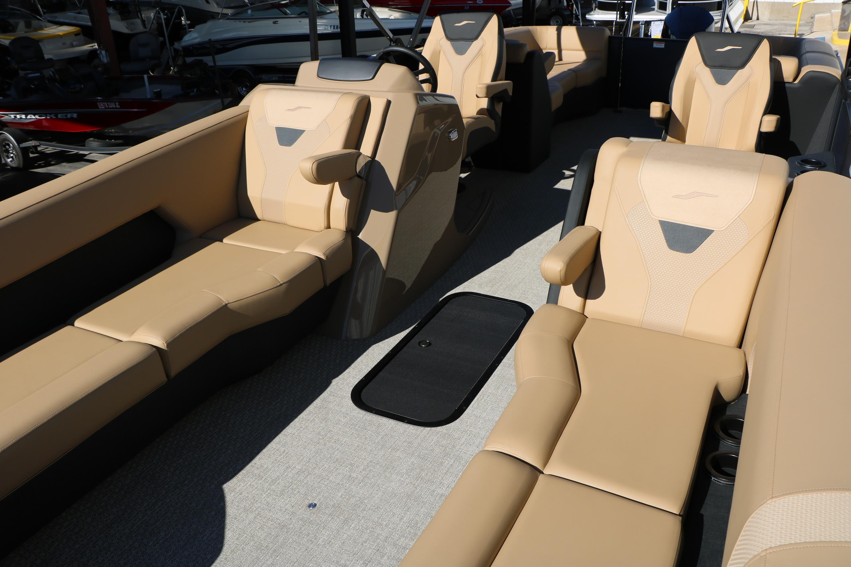 Luxurious interior of 2026 Evotti 525 QL Tri-Toon boat with beige seating.