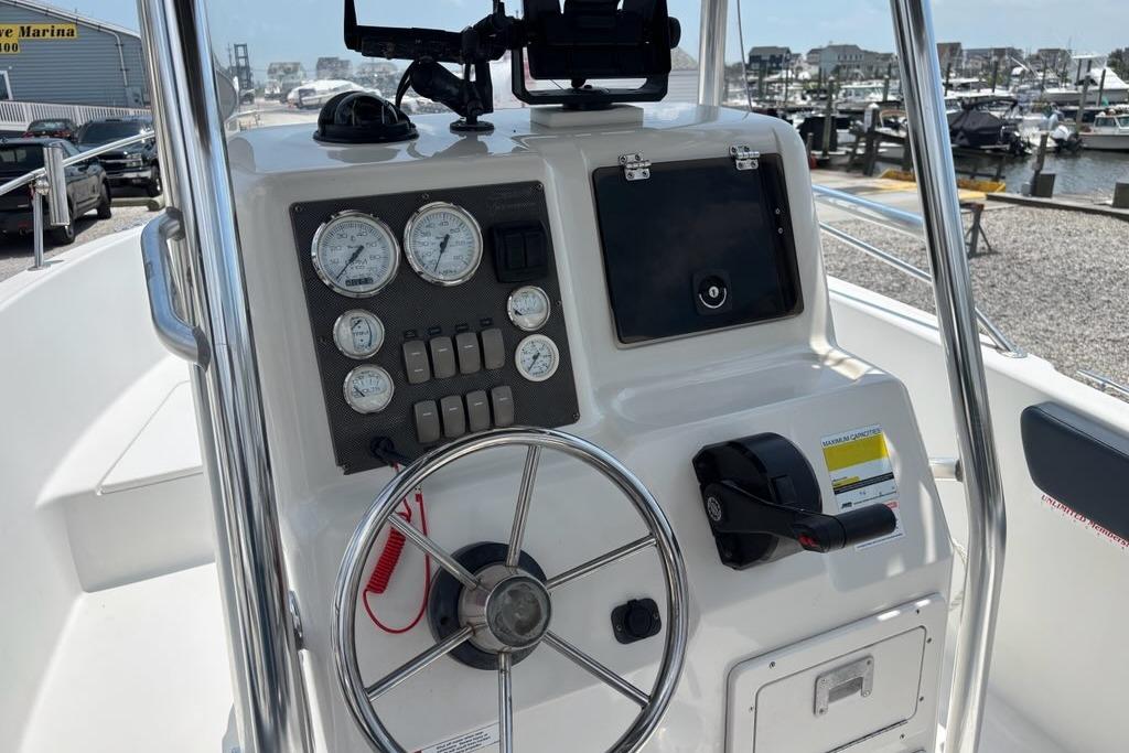 Center console of a 2002 Seaswirl Striper 2101 boat, featuring gauges and steering wheel.