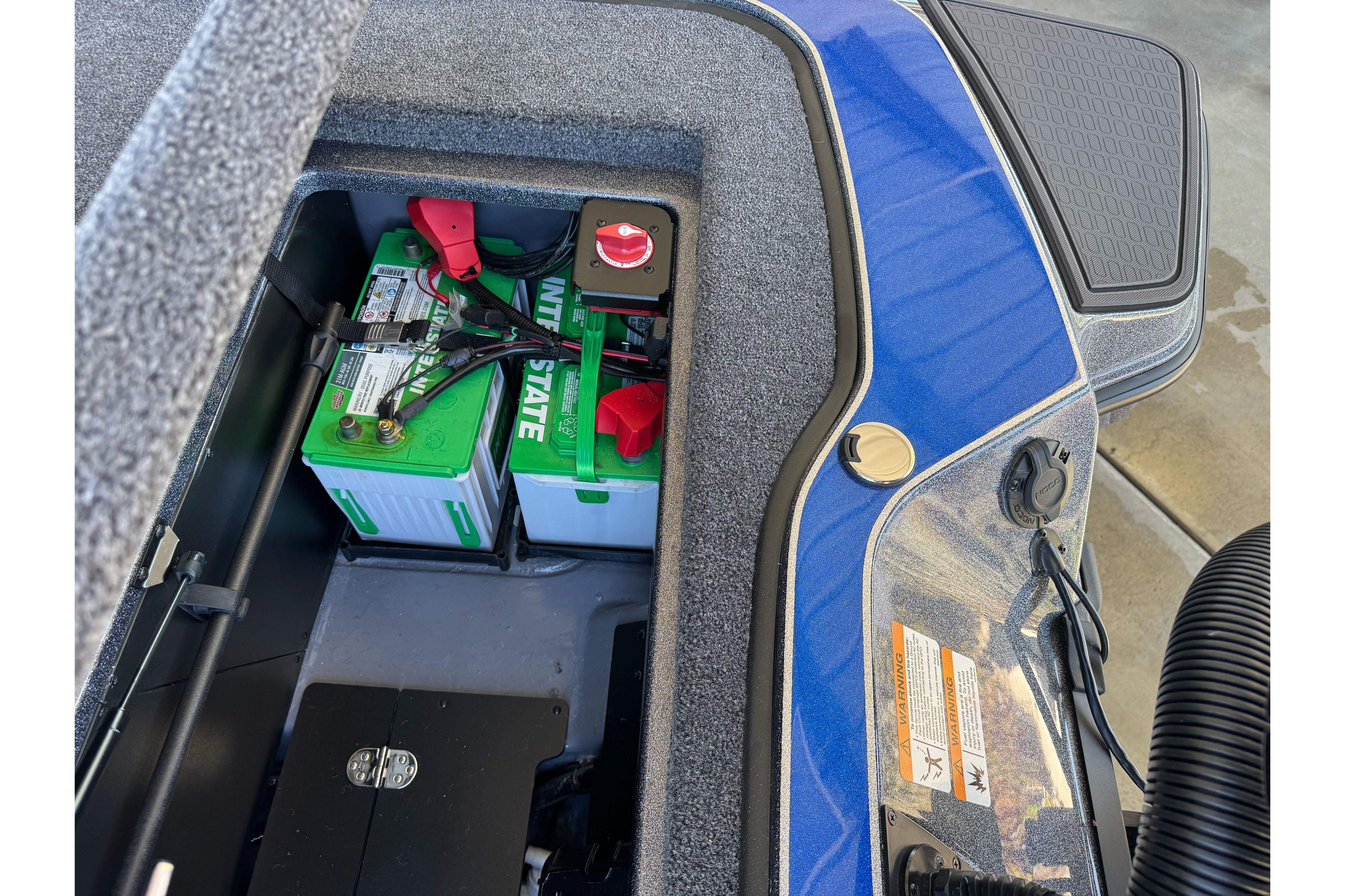 Battery compartment of 2026 Triton 21XP Patriot boat, featuring Interstate batteries and wiring.