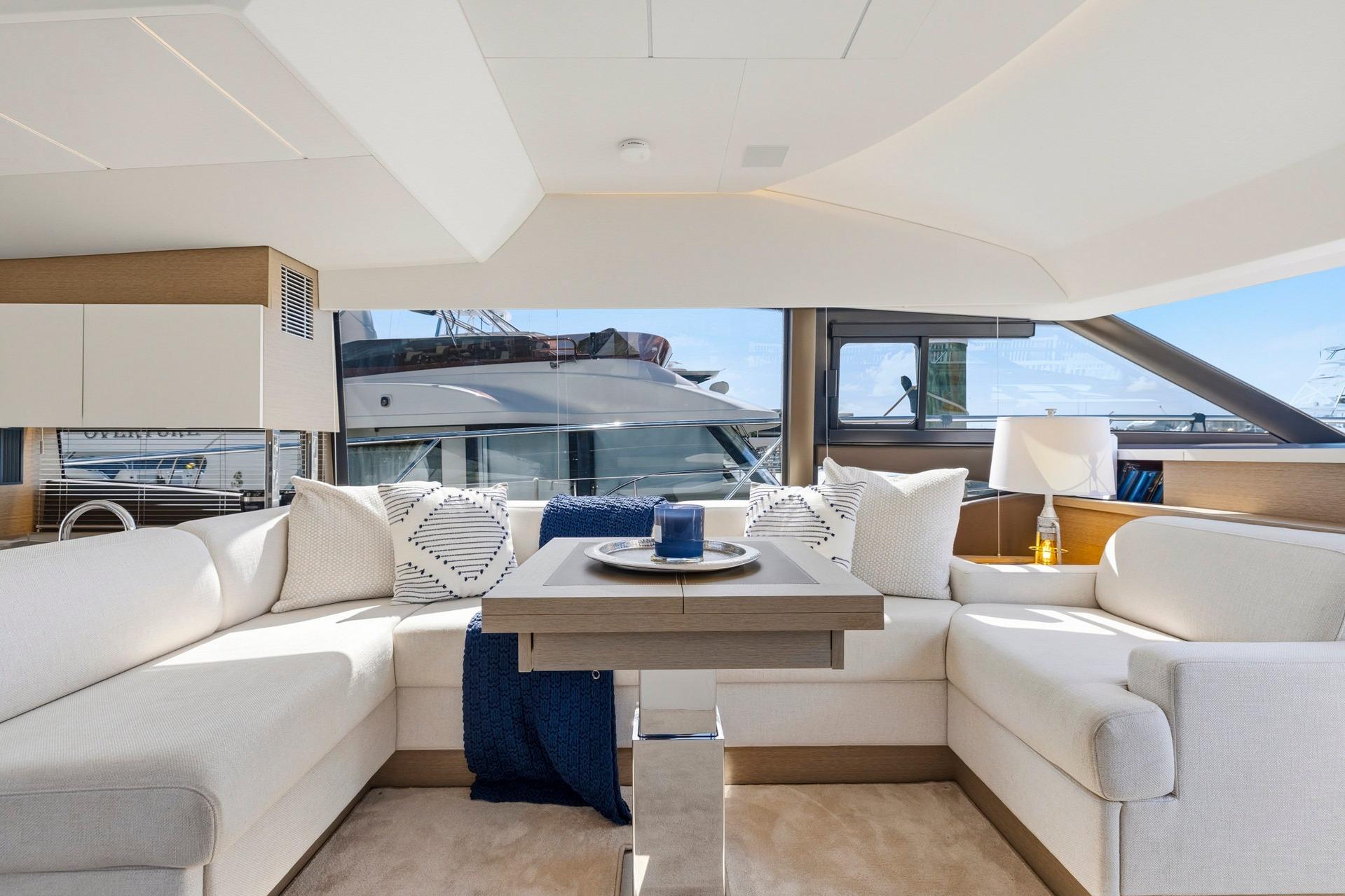 Luxurious interior of 2022 Prestige 520 yacht with elegant seating and modern decor.