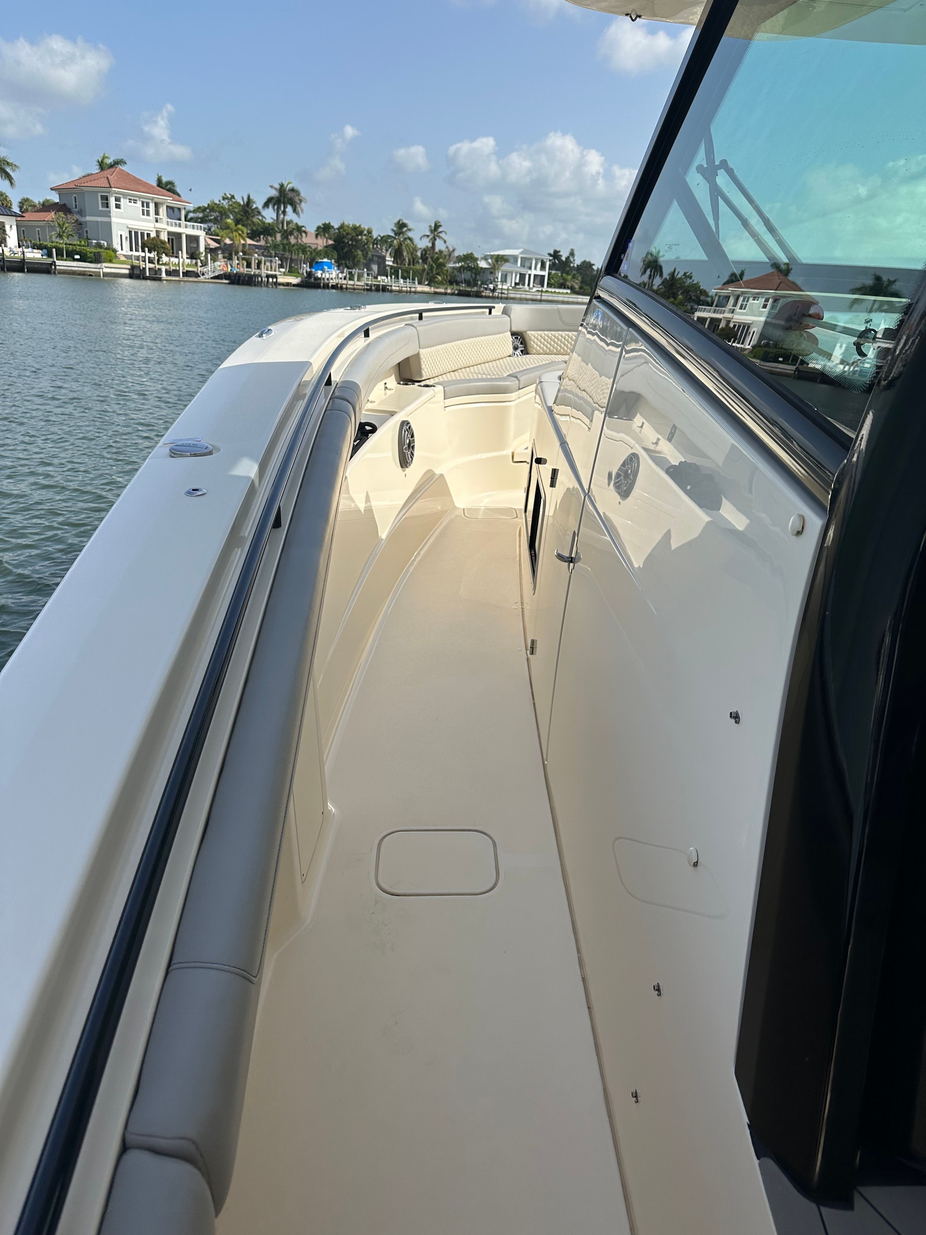 Scout 425 LXF 2022 on water with coastal view.