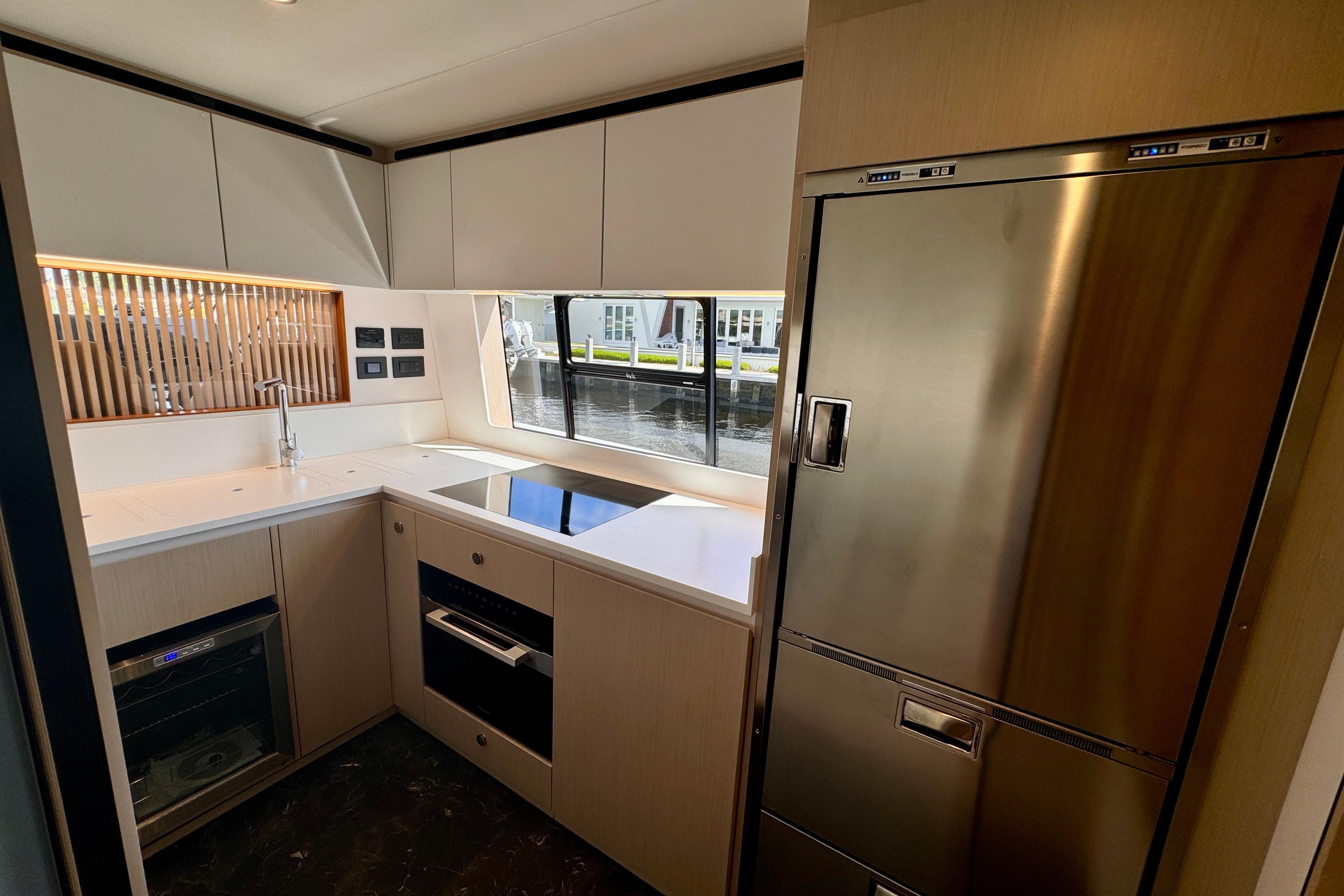 Modern kitchen interior of 2025 Azimut Fly 68 yacht with sleek appliances and cabinetry.