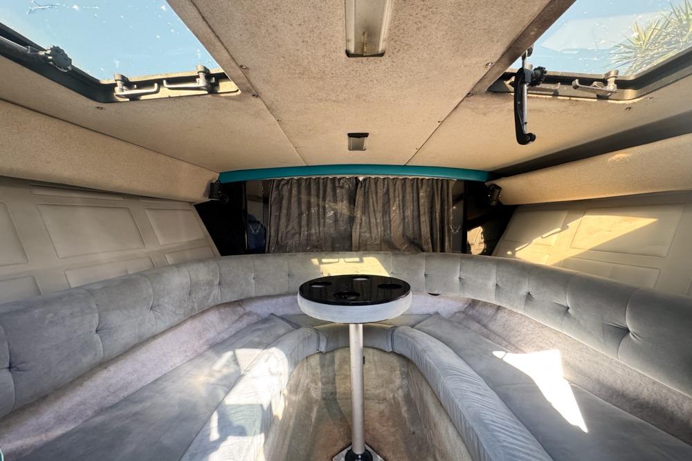 Interior of a 1989 Formula 292 SR-1 boat with plush seating and a small table.
