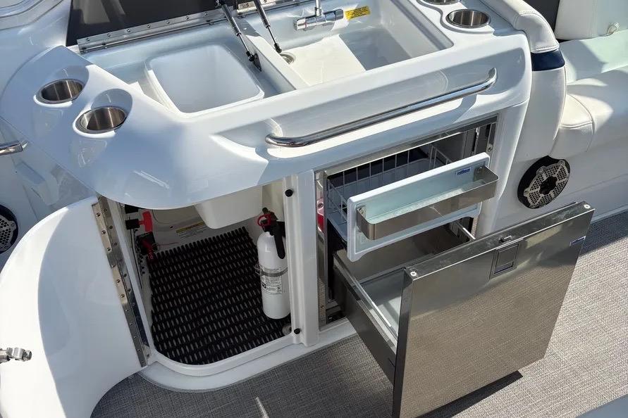 2015 Formula 350 Crossover Bowrider boat kitchen with sink, fridge, and storage.