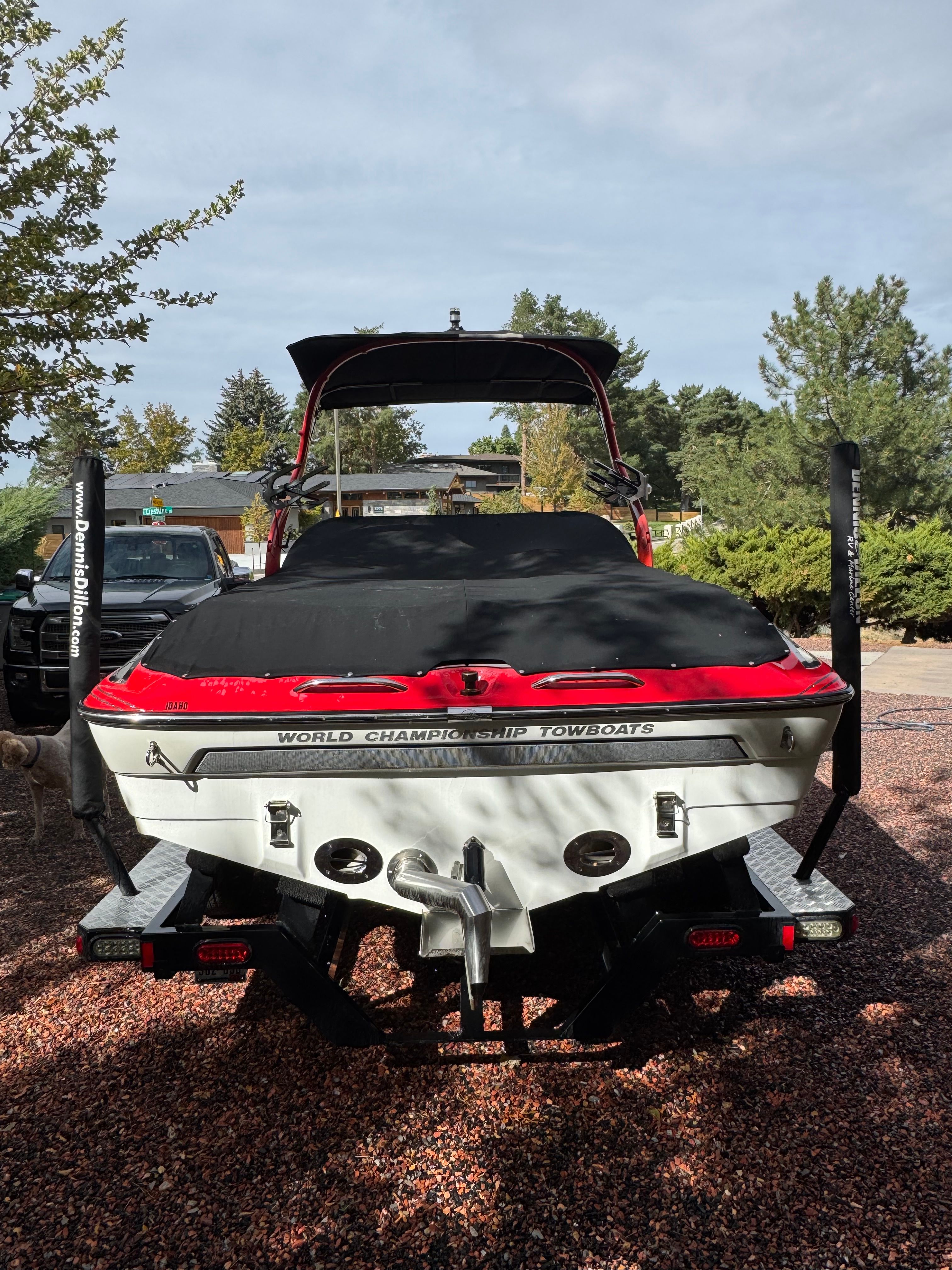 A 2013 Centurion Enzo SV211 on a gravel path. The boat is covered with a black cover.
