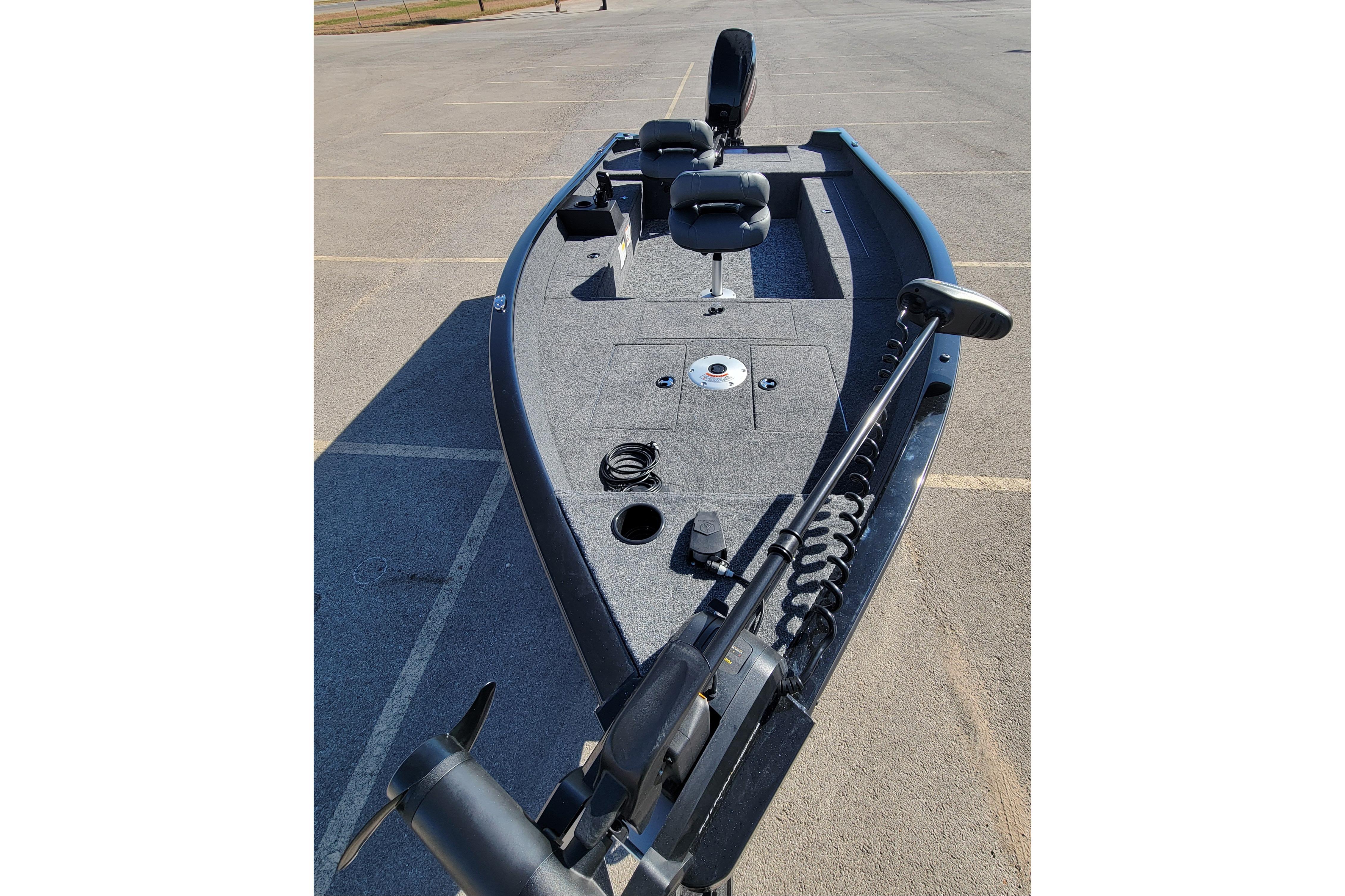 2026 Tracker Super Guide V-16 T fishing boat in a parking lot.