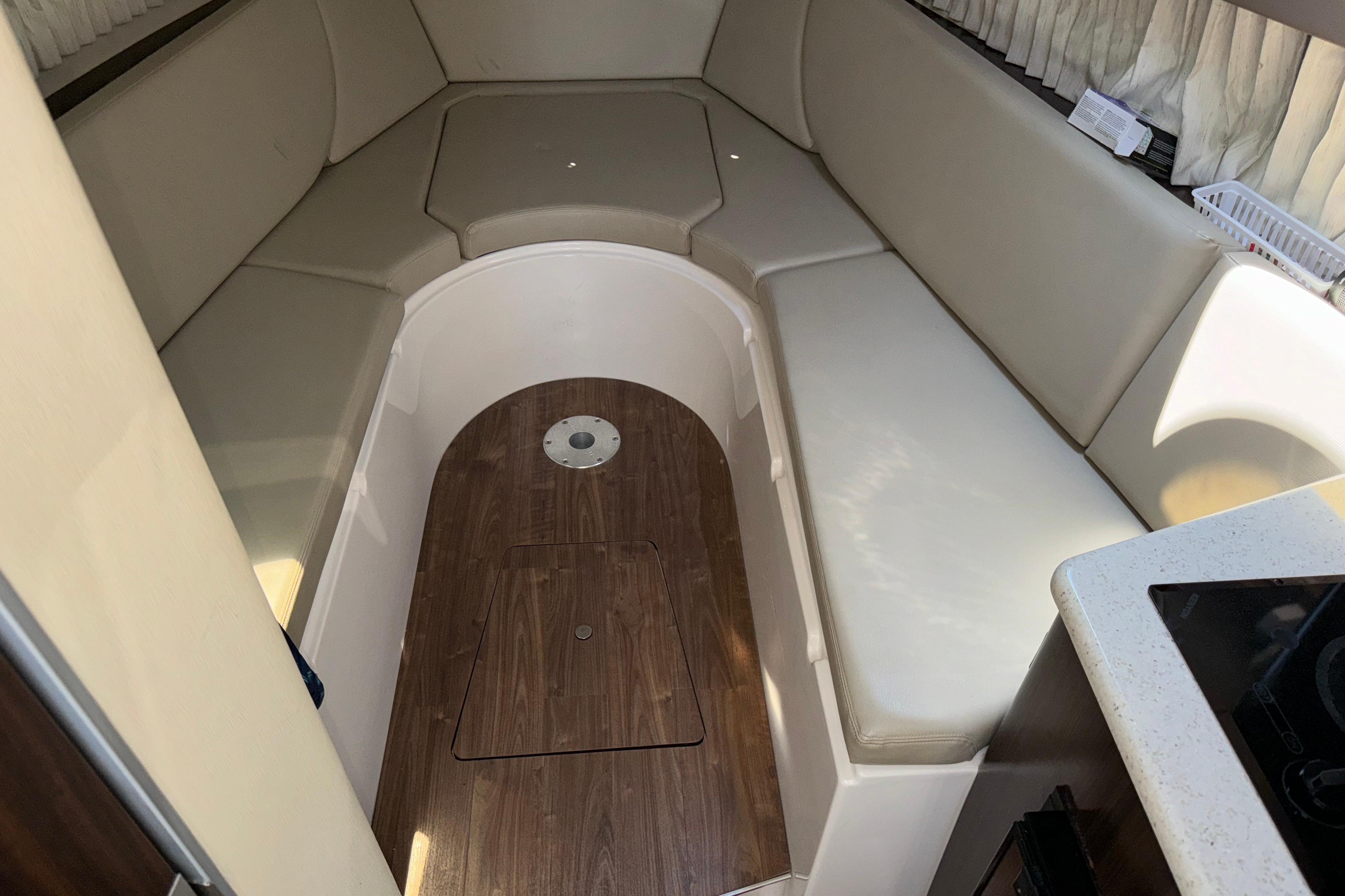 Interior cabin of 2017 Regal 28 Express boat with beige seating and wood flooring.