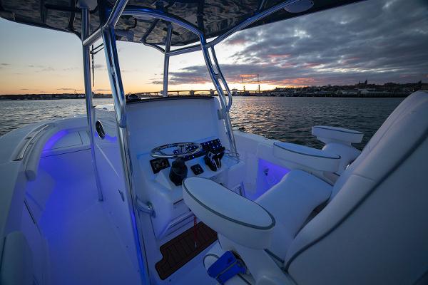 Manufacturer Provided Image: 2025 Southport 27 FE boat interior at sunset, featuring illuminated controls and seating.