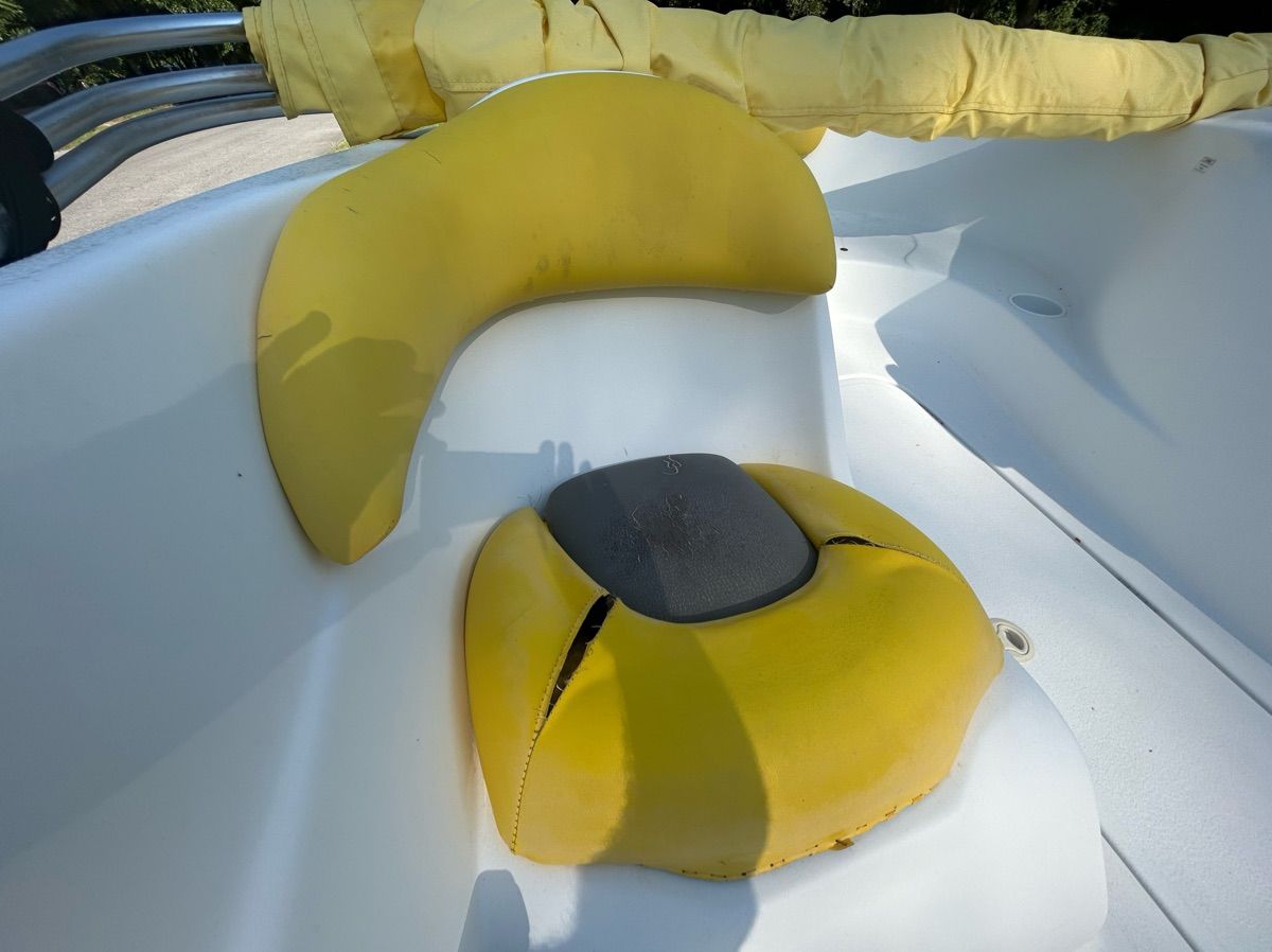 Yellow seat in a 2004 Sea-Doo Sportster LE DI, with a white background.