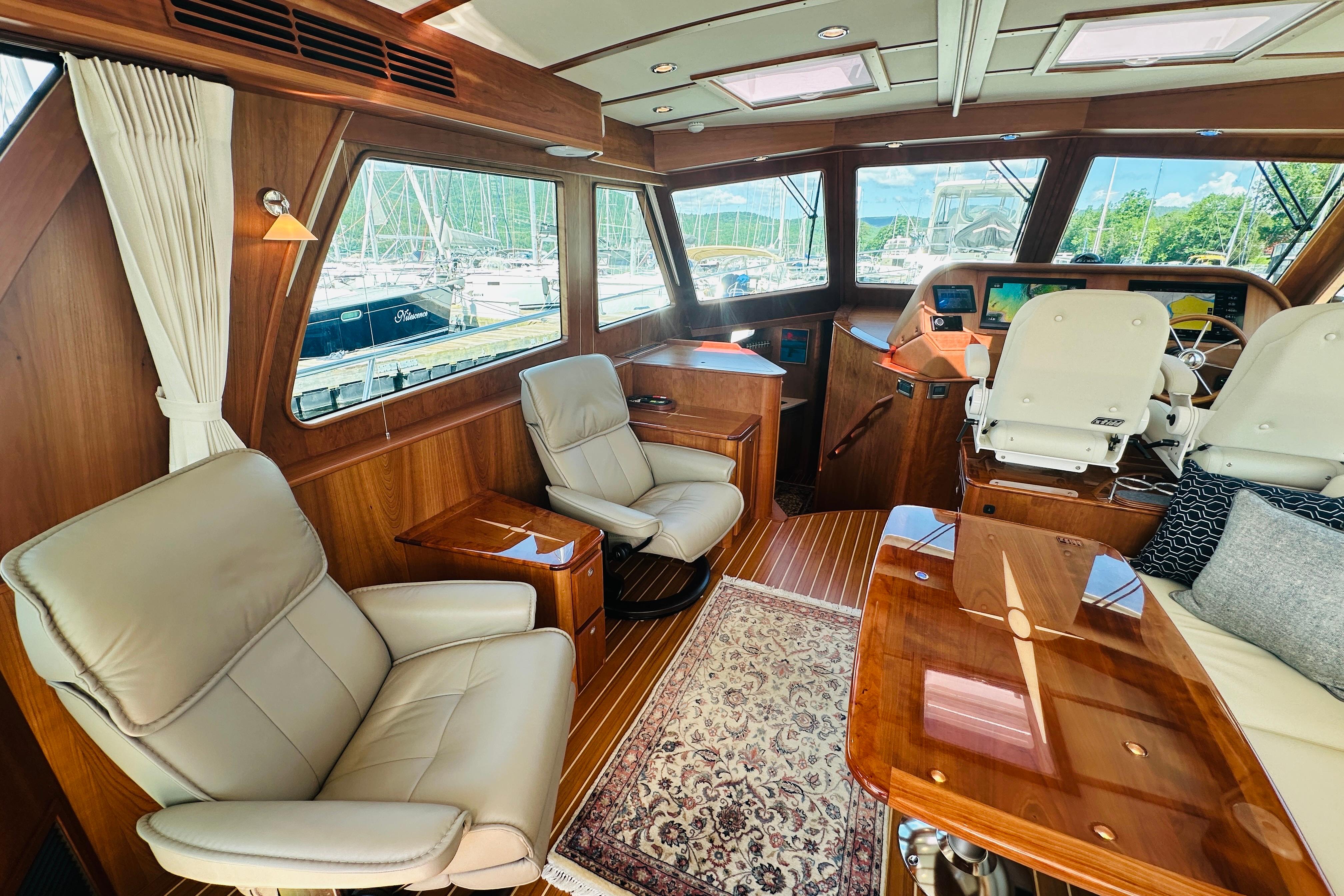 Luxurious interior of 2025 Sabre 48 Salon Express yacht with elegant seating and wood finishes.