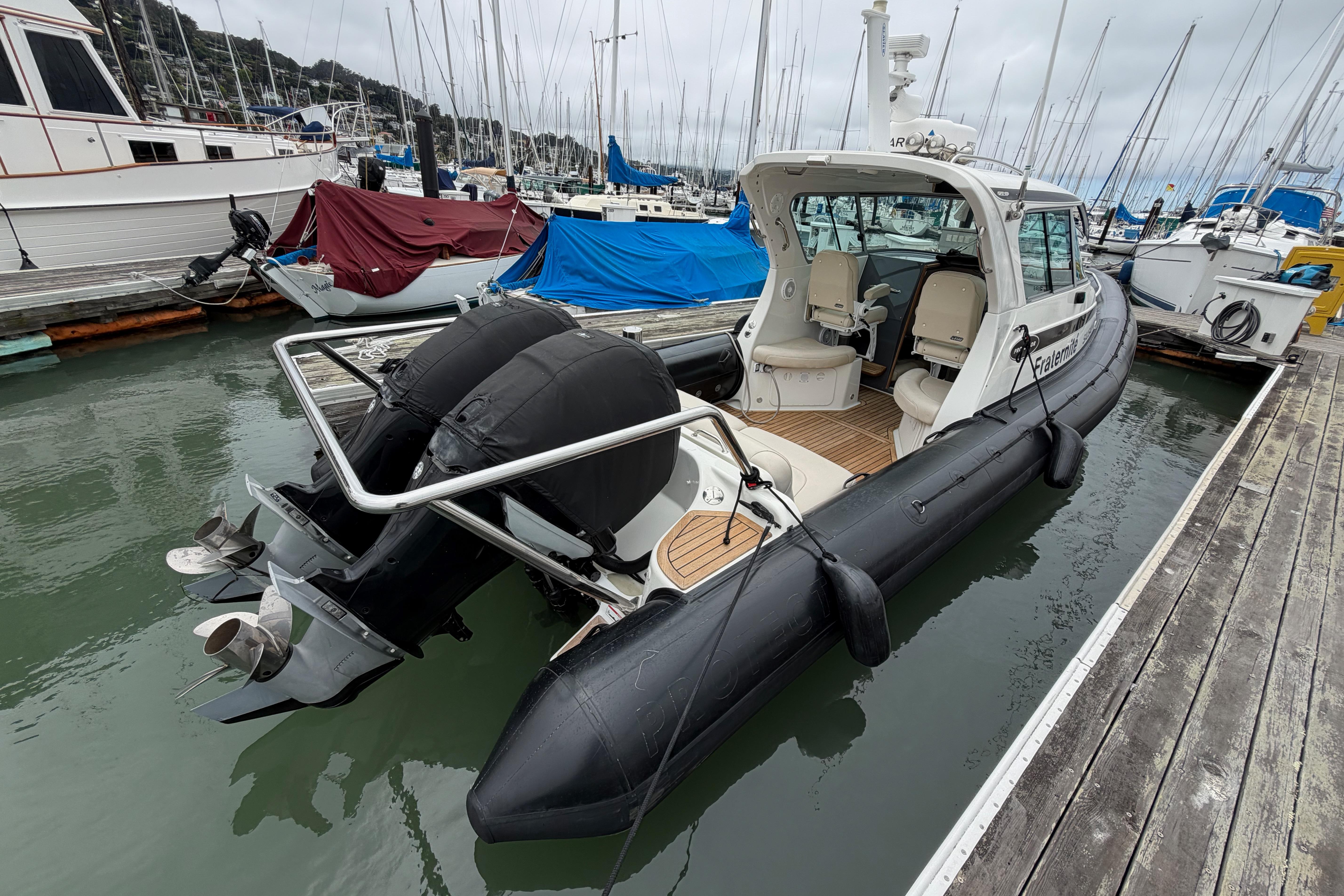 2016 Protector Targa 30 boat docked at marina with twin outboard engines.