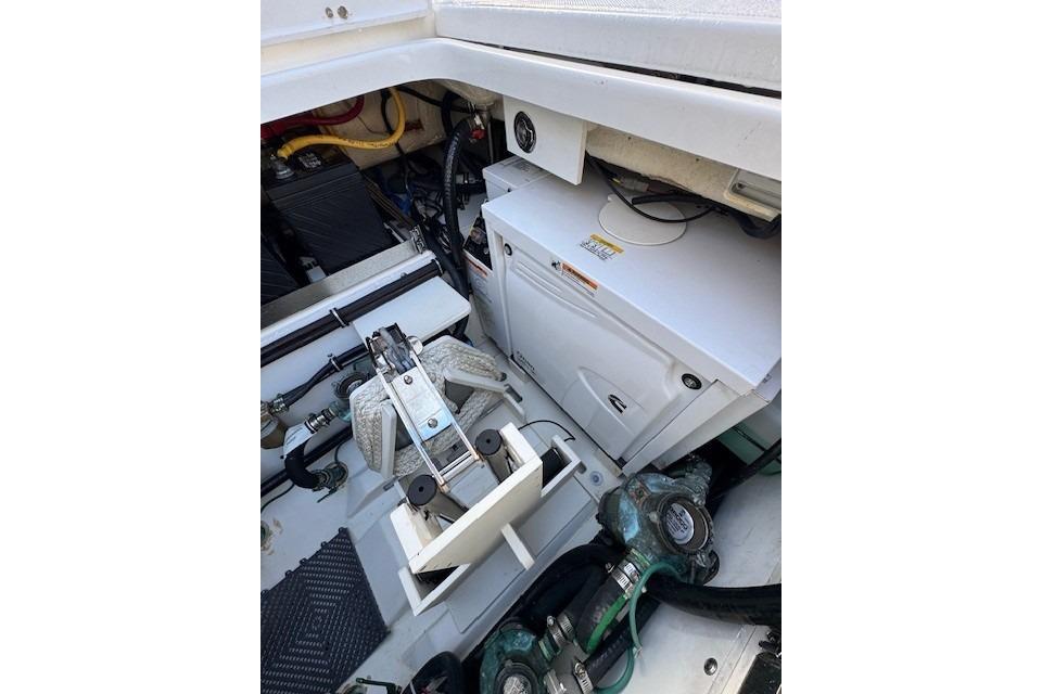 2023 Pursuit S 428 Sport boat engine compartment with mechanical components and wiring.