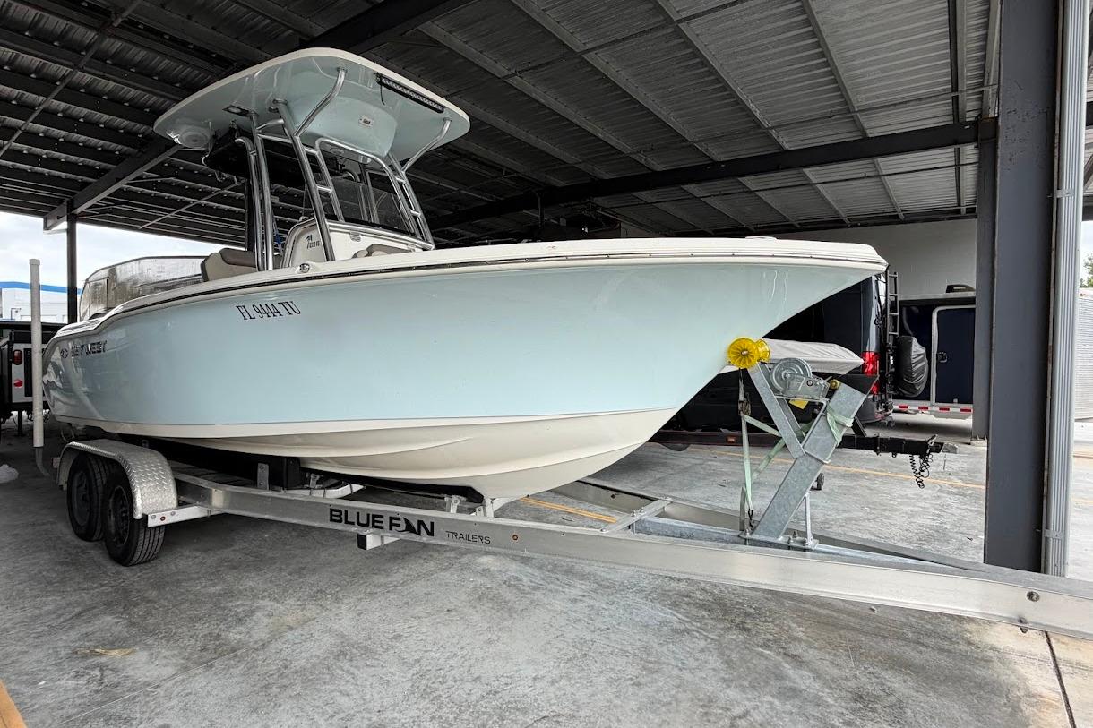 2024 Key West 219 FS boat on trailer in covered storage area.
