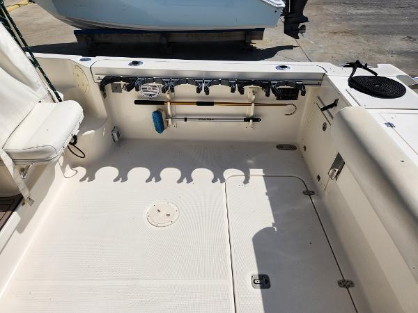 2005 Pursuit 3070 Offshore Center Console boat deck with rod holders and seating.