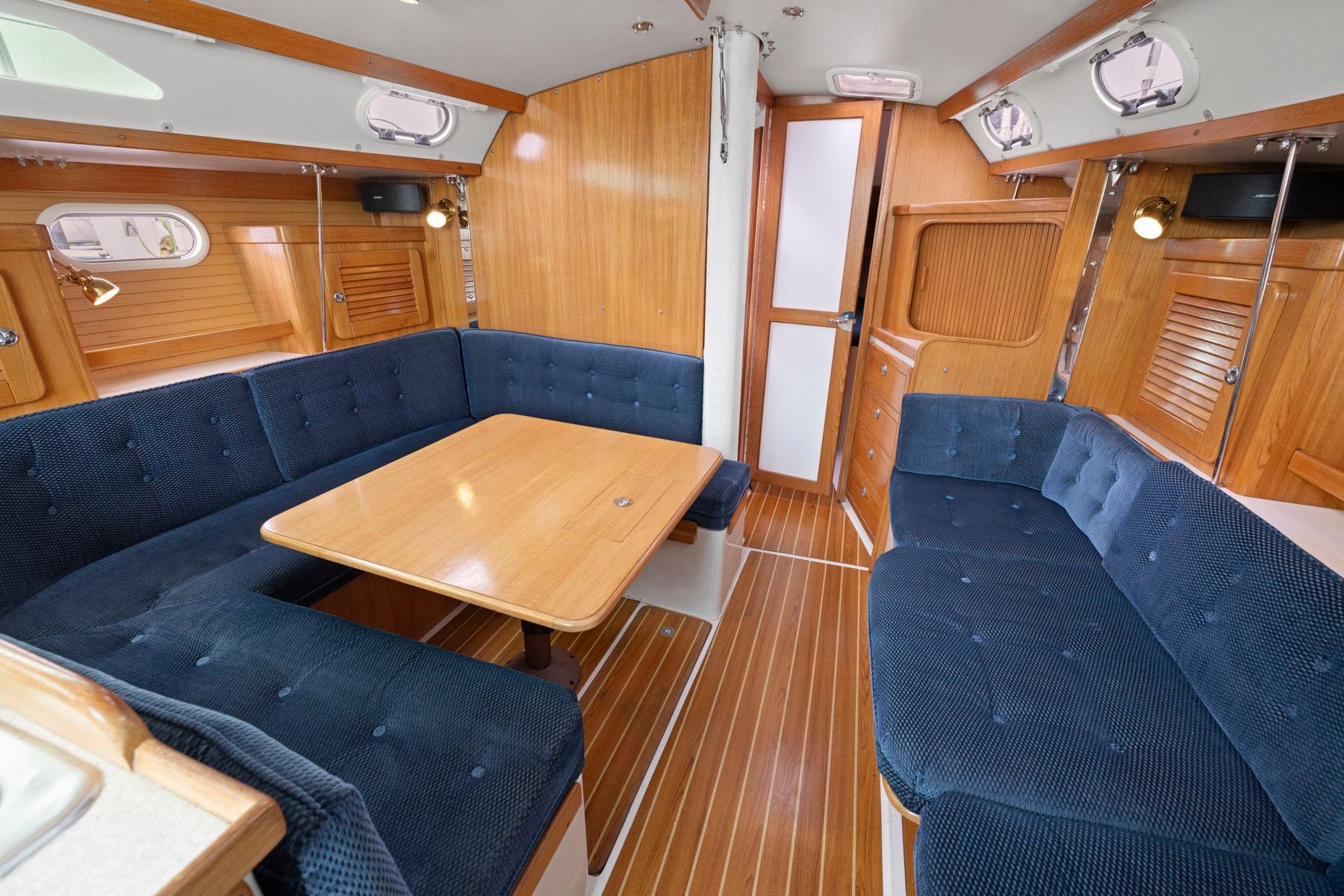 Interior of 2004 Catalina 36 MkII sailboat with blue seating and wooden accents.