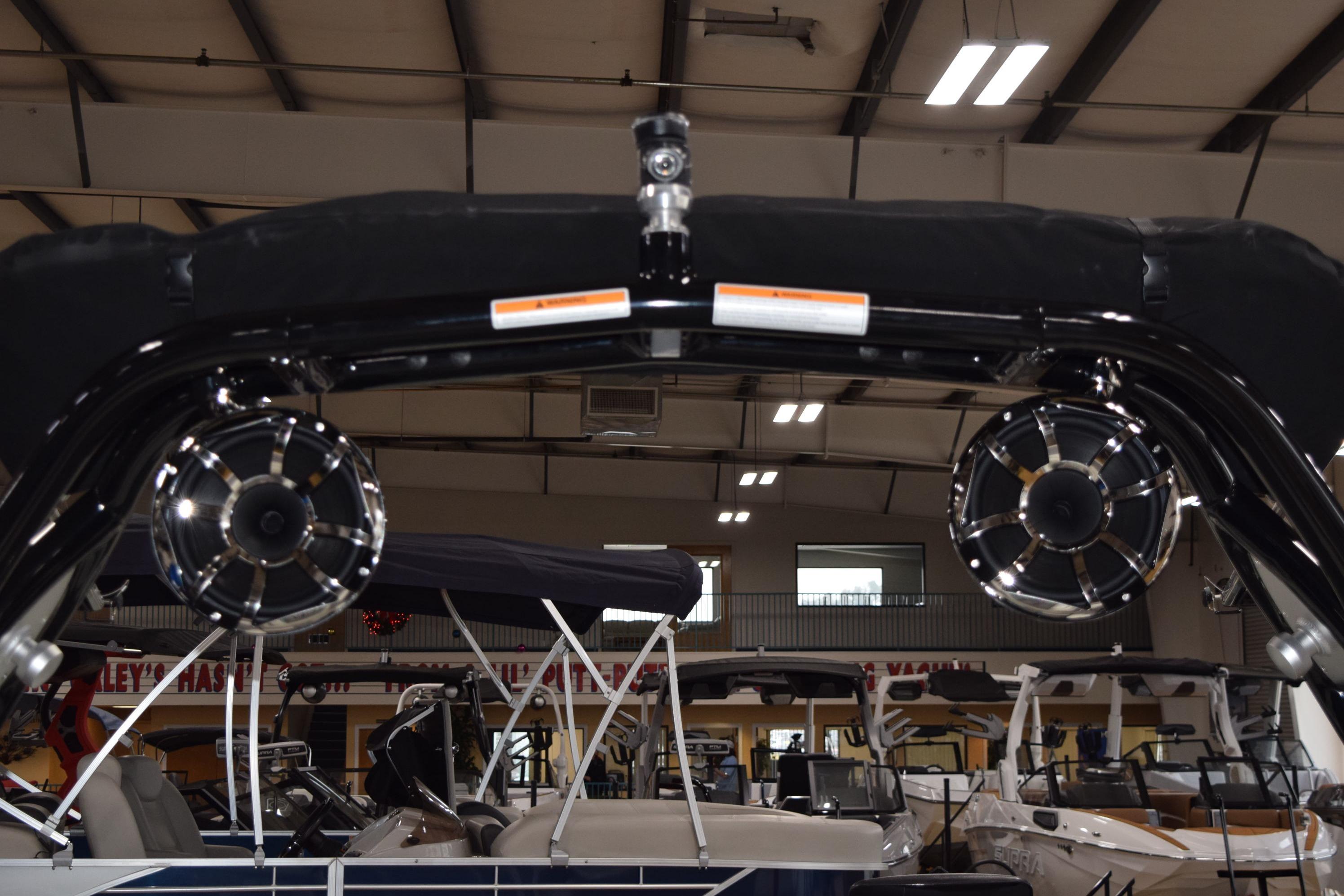 2025 Moomba Mojo boat with speakers in a showroom setting.