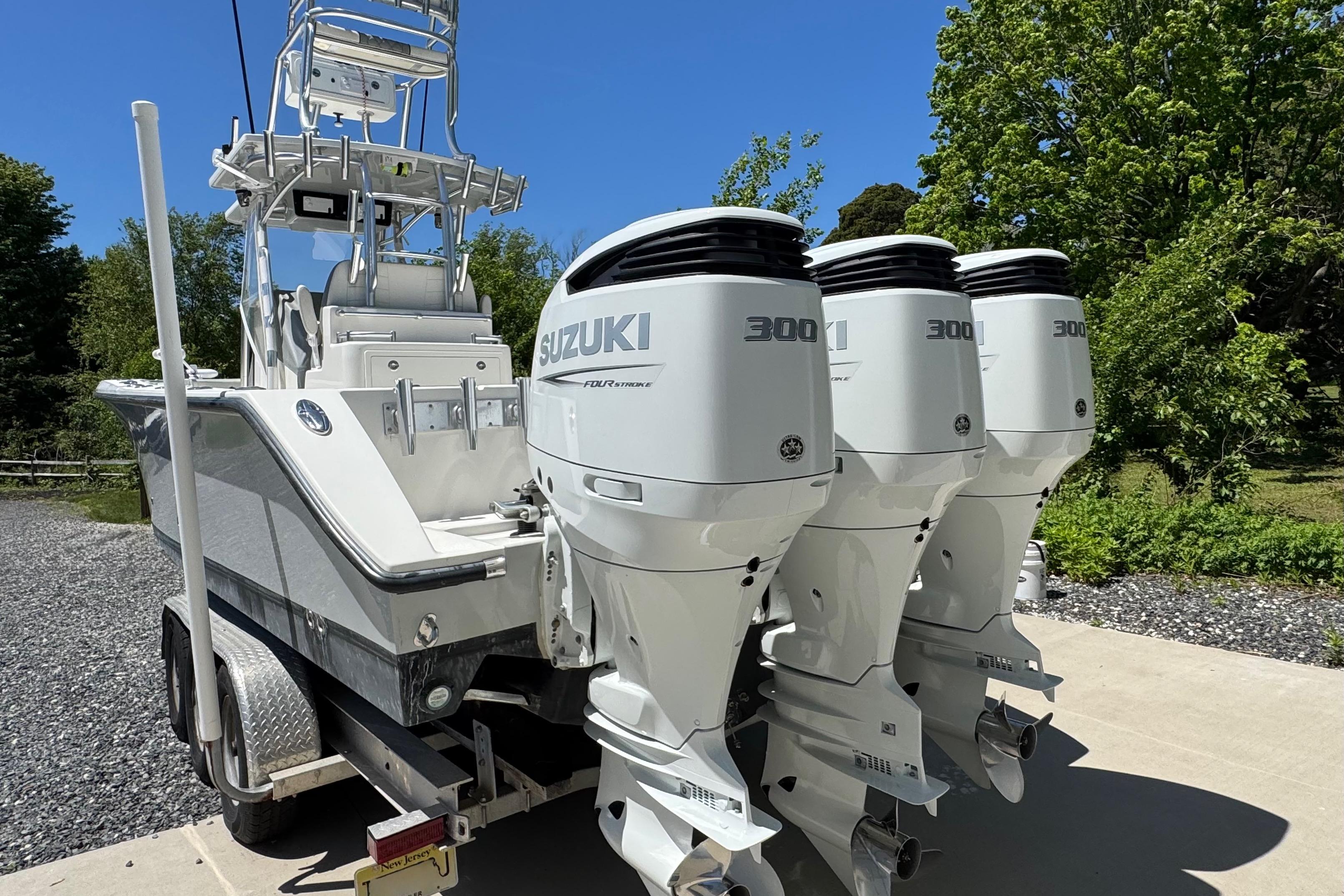 2020 Sea-Lion 34 TE boat with triple Suzuki 300 outboard engines on a trailer.
