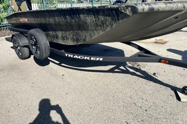 2026 Tracker Grizzly 1756 T Marsh boat on trailer, parked on pavement.