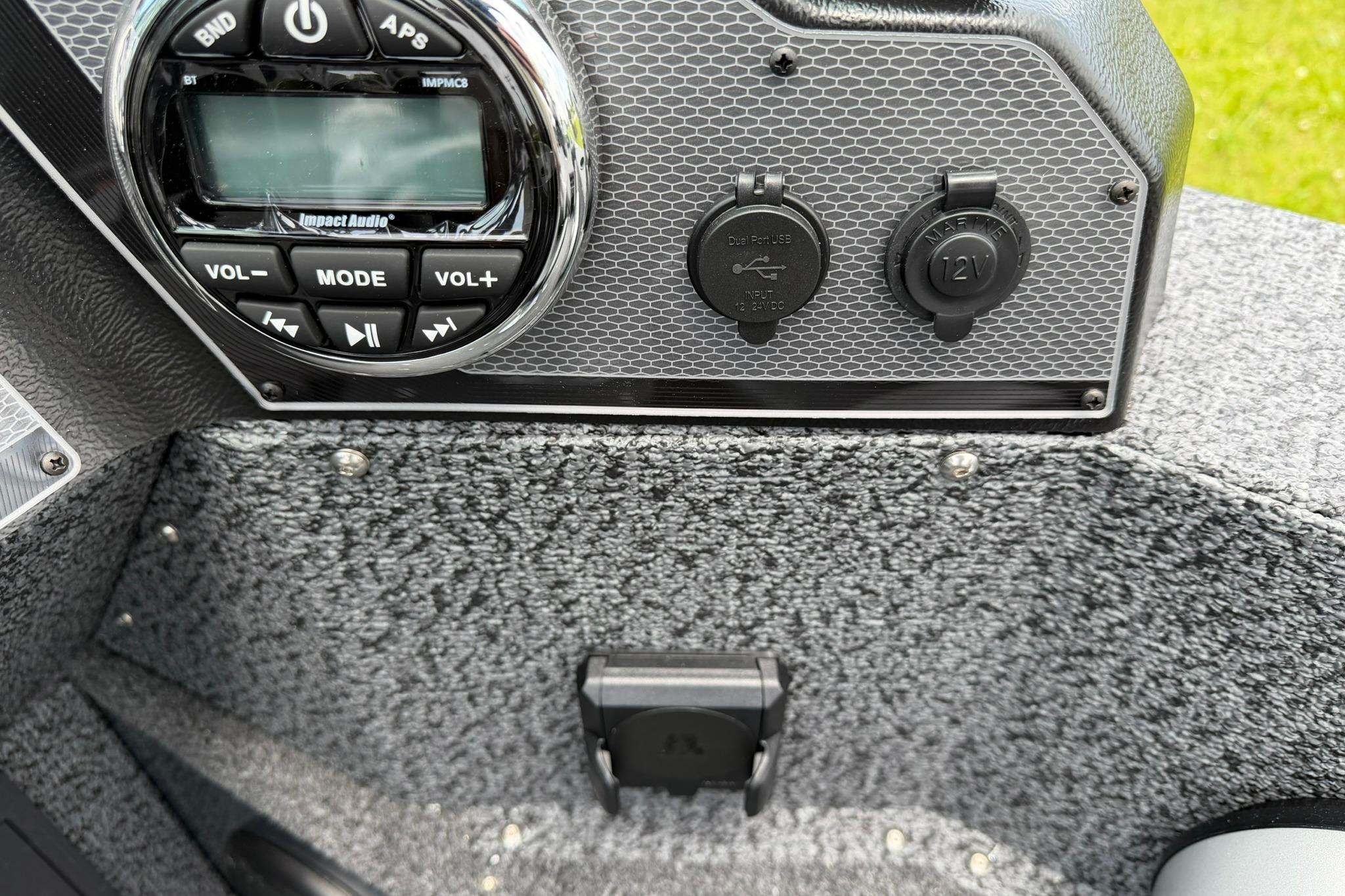 2027 Lund 1675 Adventure Sport dashboard with audio controls and power outlets.