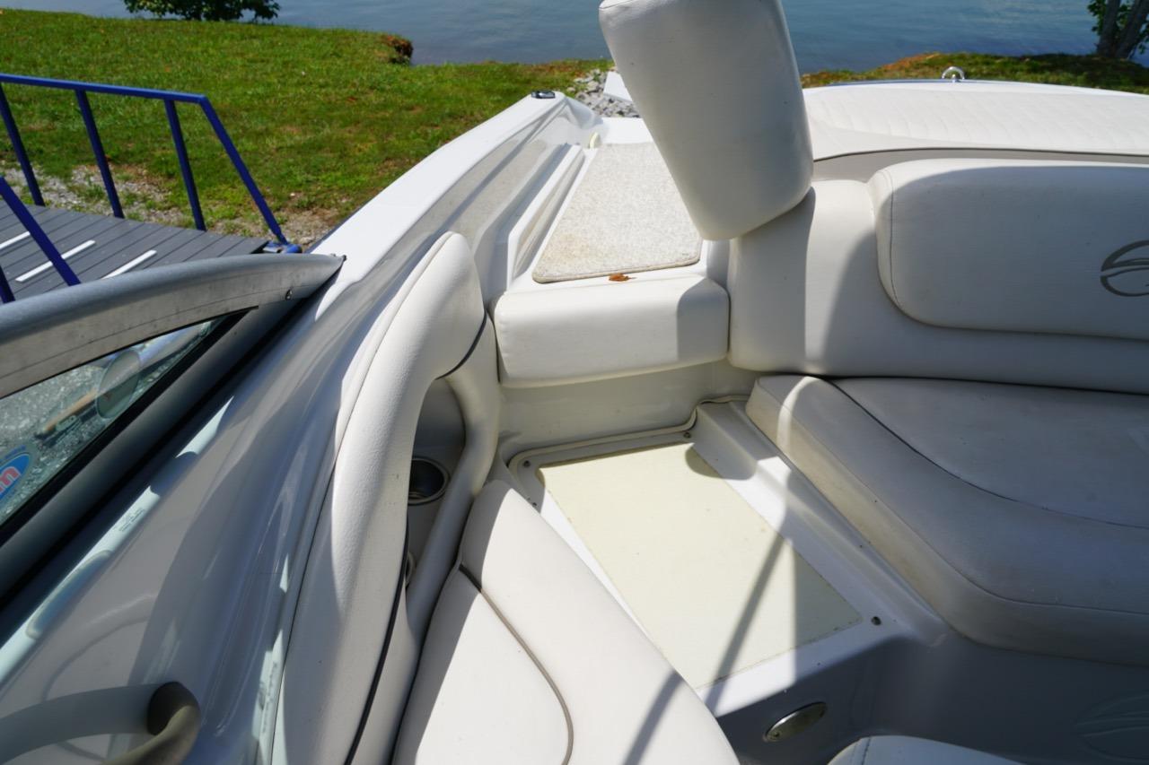Interior of a 2004 Crownline 216 LS boat with white seating and lake view.