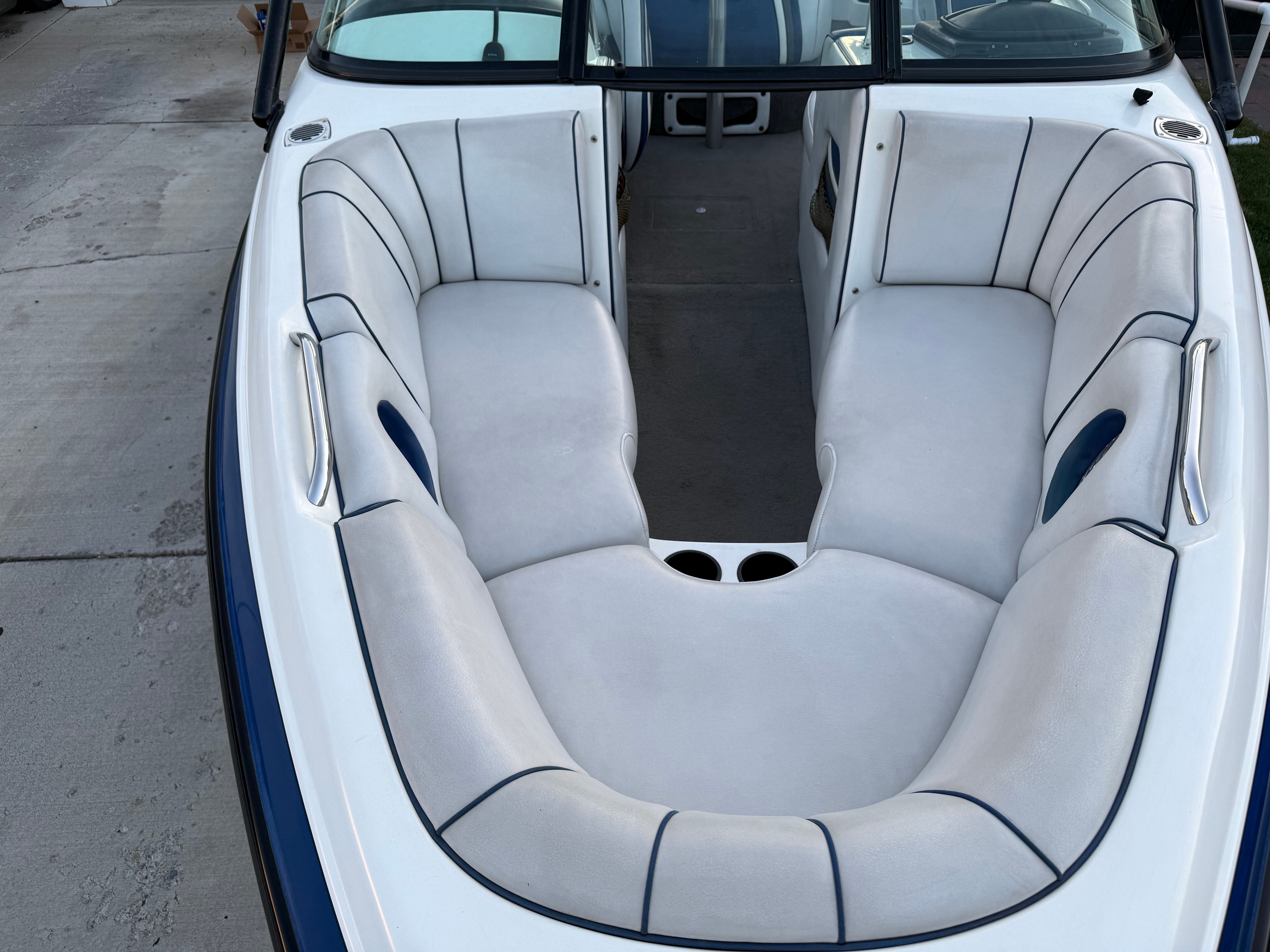 Interior of a 2004 MB Sports 220 boat with white seating.
