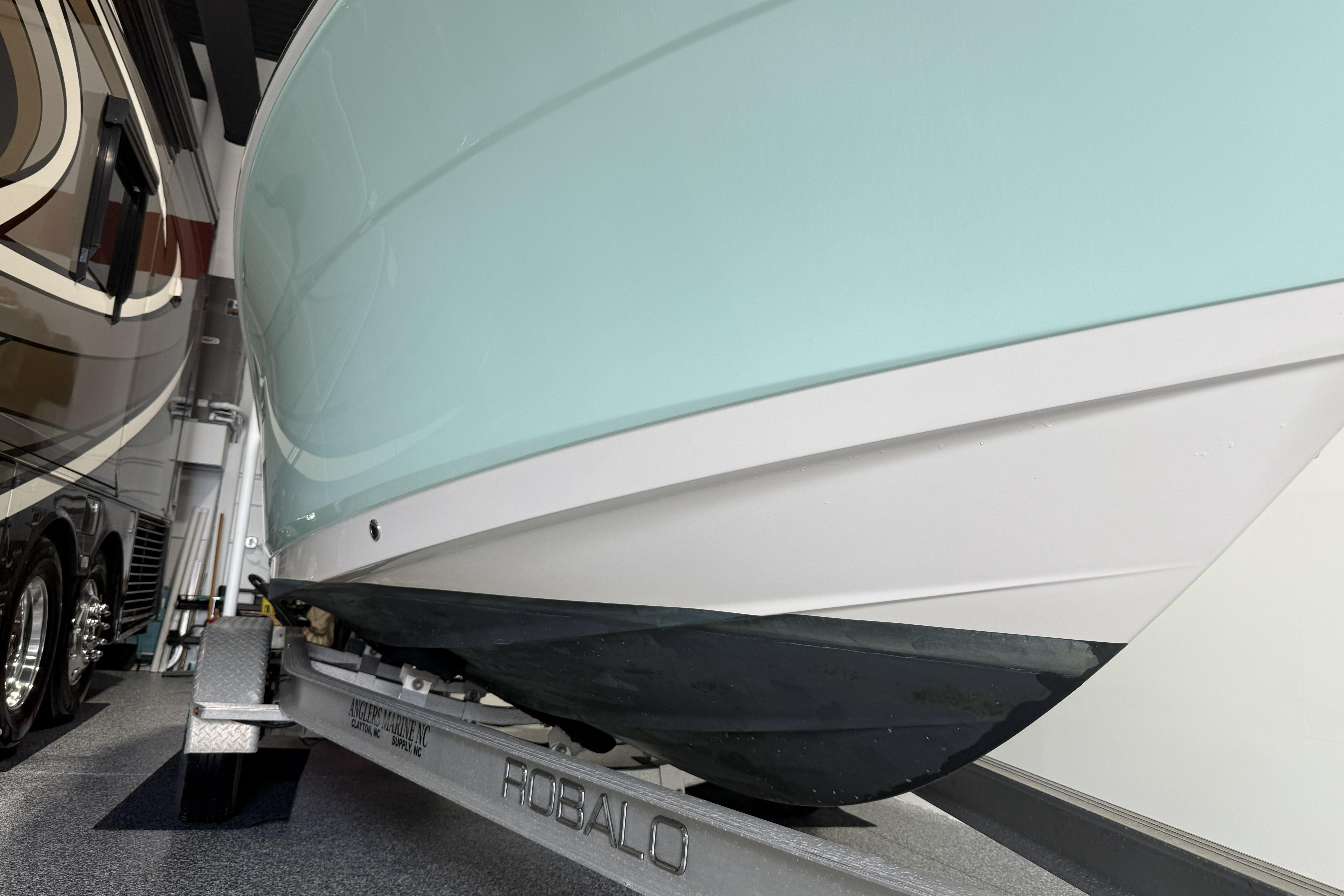 2021 Robalo R200 Center Console boat on trailer in garage.