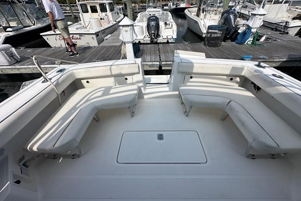 2006 Tiara Yachts 2900 Coronet boat interior with white seating at a marina.