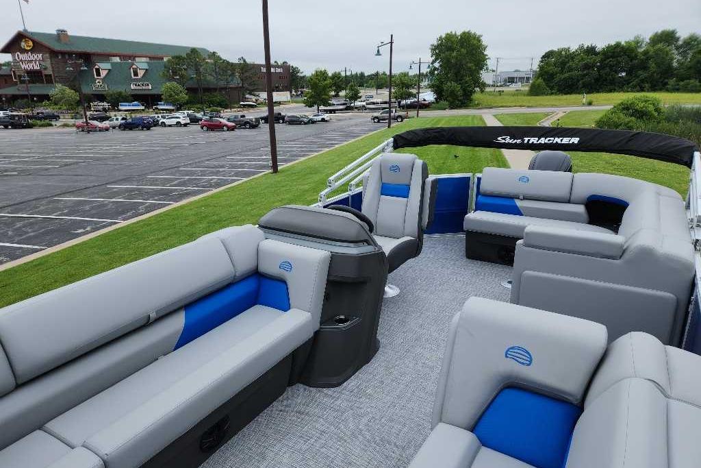 2026 Sun Tracker Party Barge 20 DLX pontoon boat with spacious seating in a parking lot.