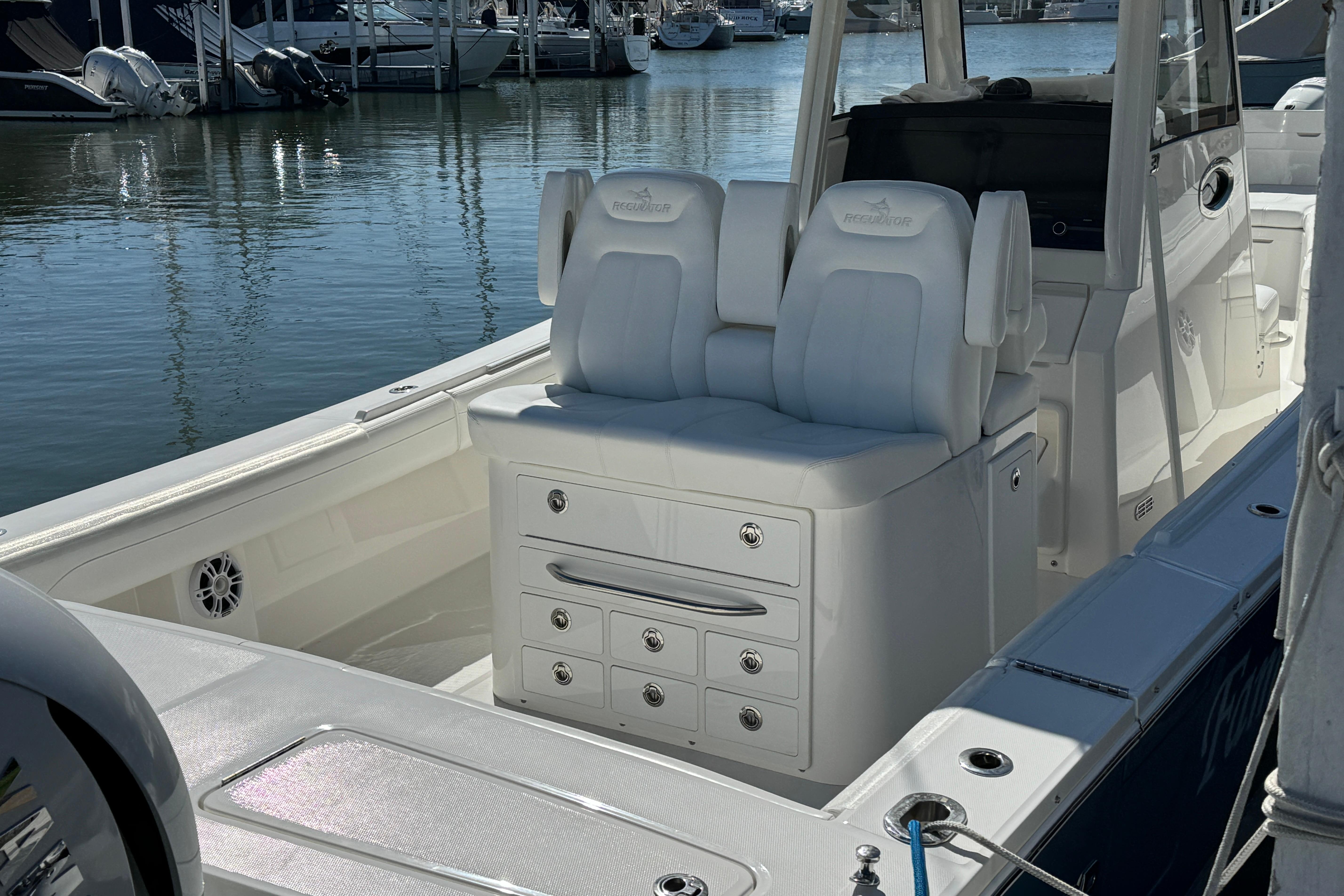 2021 Regulator 31 boat interior with white seating and storage, docked at marina.