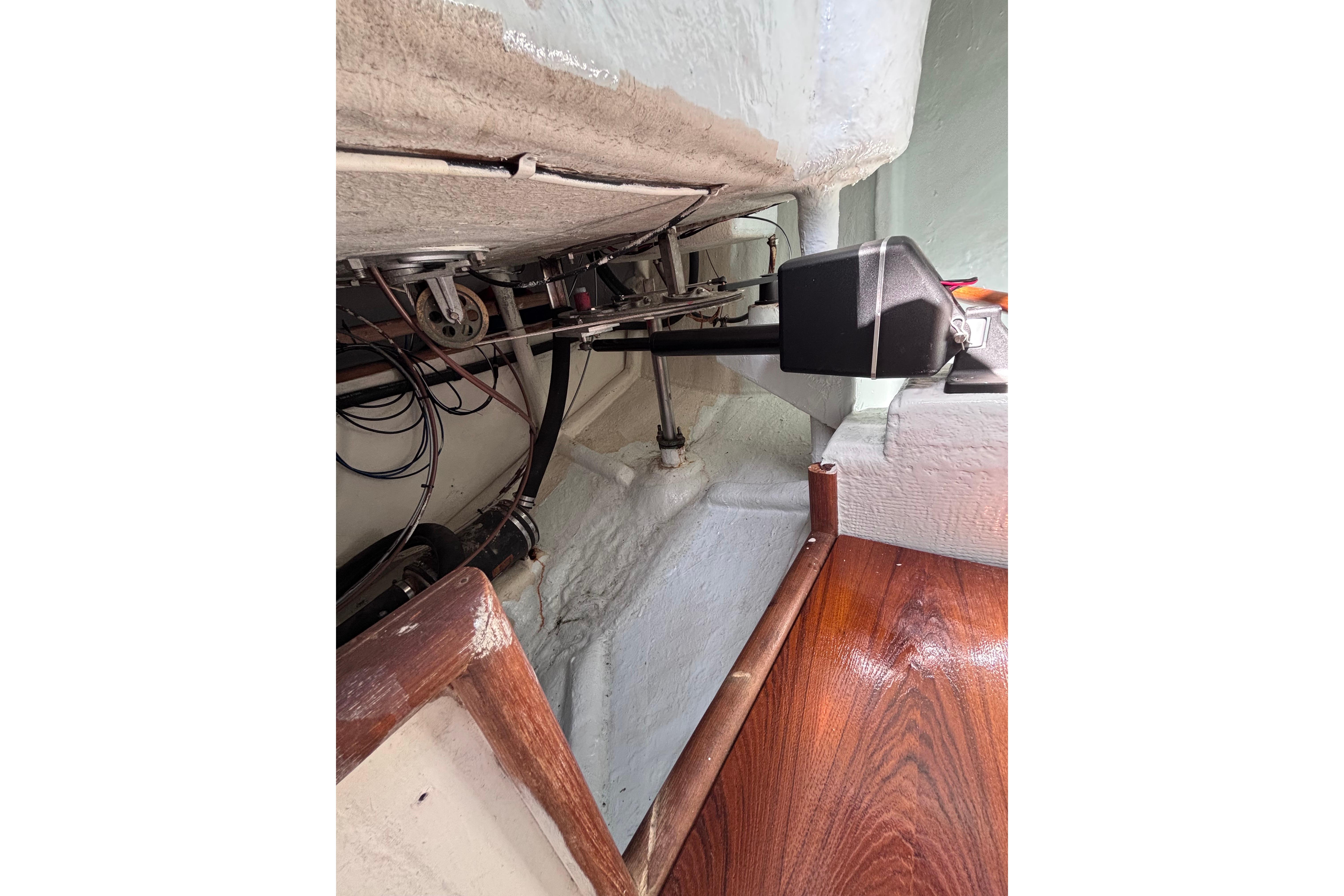 Interior view of a 1978 Swift 33 boat showing mechanical components and wooden flooring.