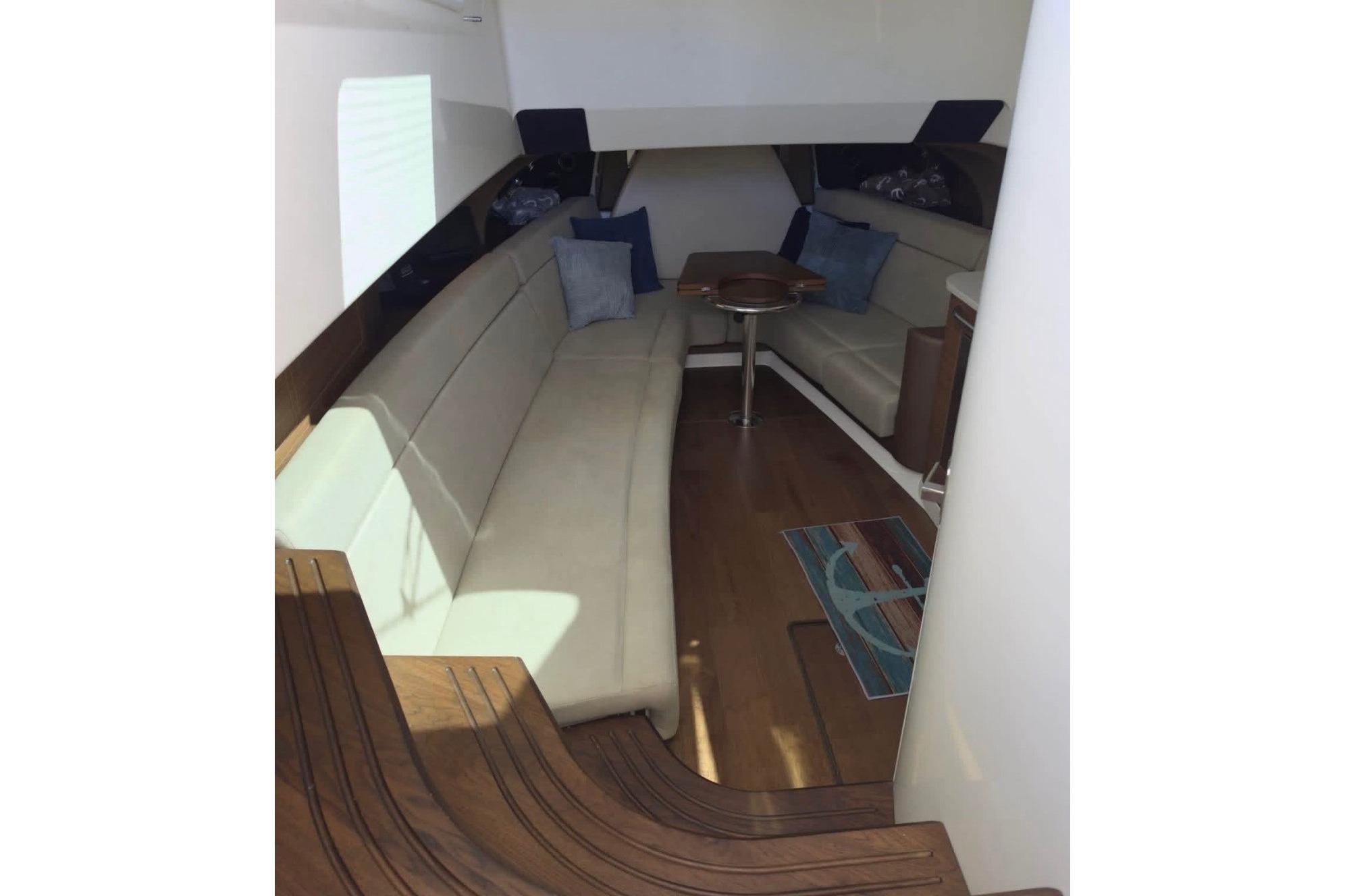 Interior of 2020 Boston Whaler 420 Outrage, featuring elegant seating and wooden flooring.