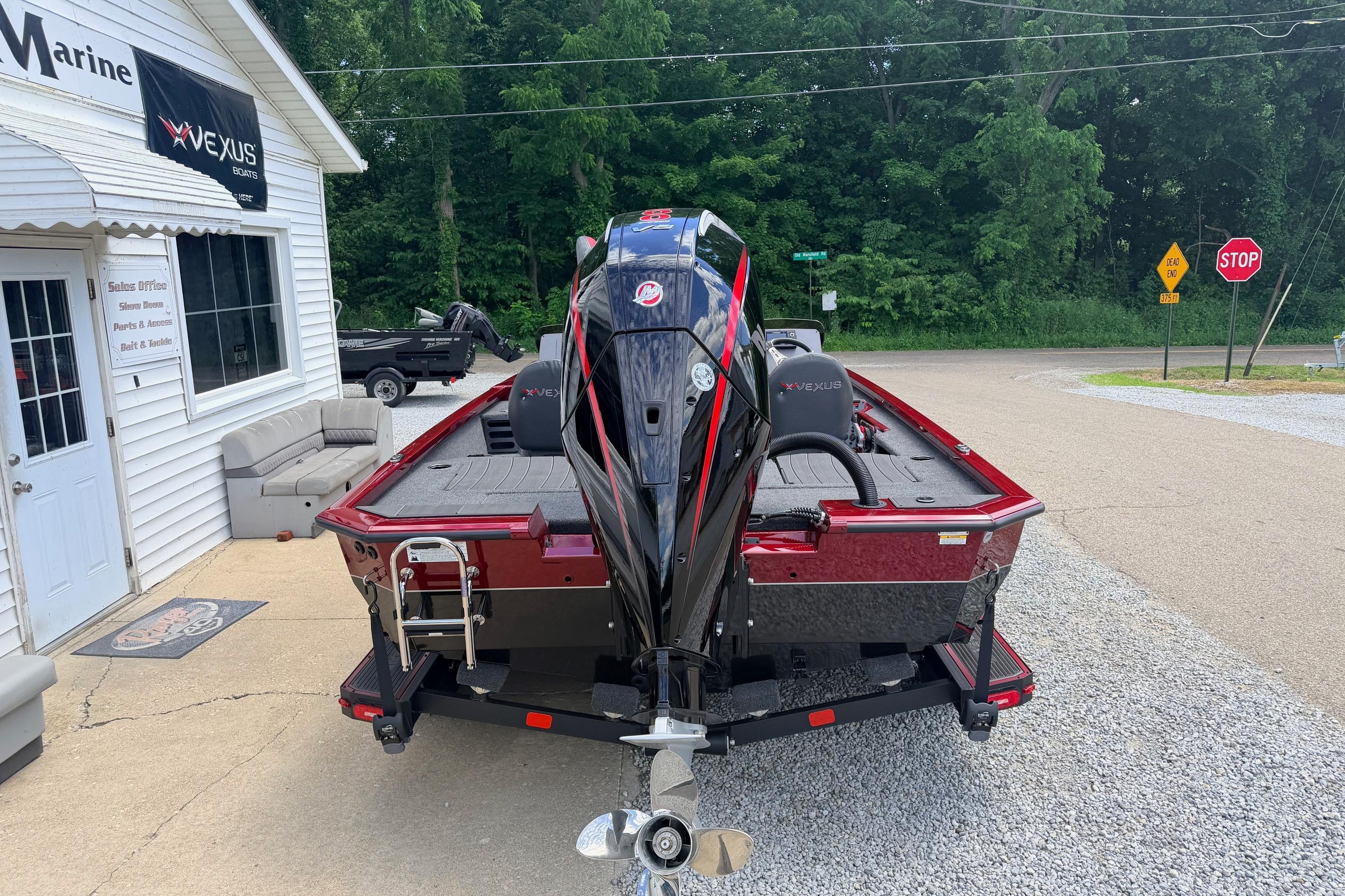2026 Vexus AVX1985s boat parked outside a marine dealership.